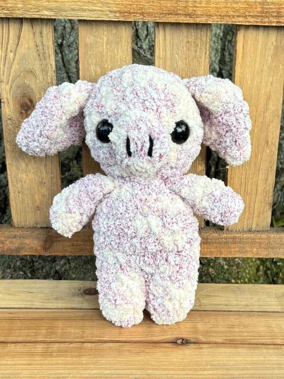 Close up of crochet pig plushie face and snout