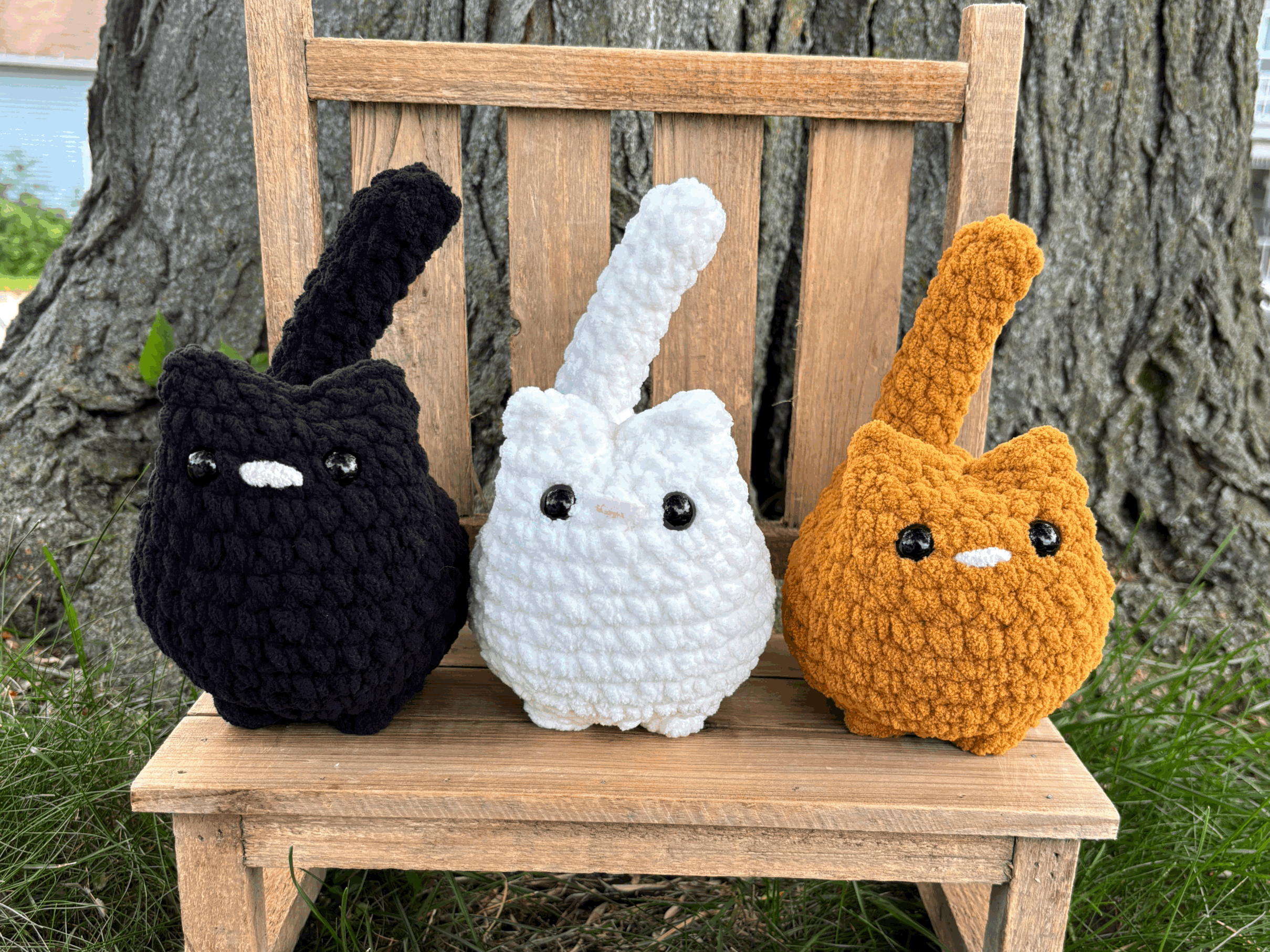 Handmade crochet cat plushie trio in black, white, and orange