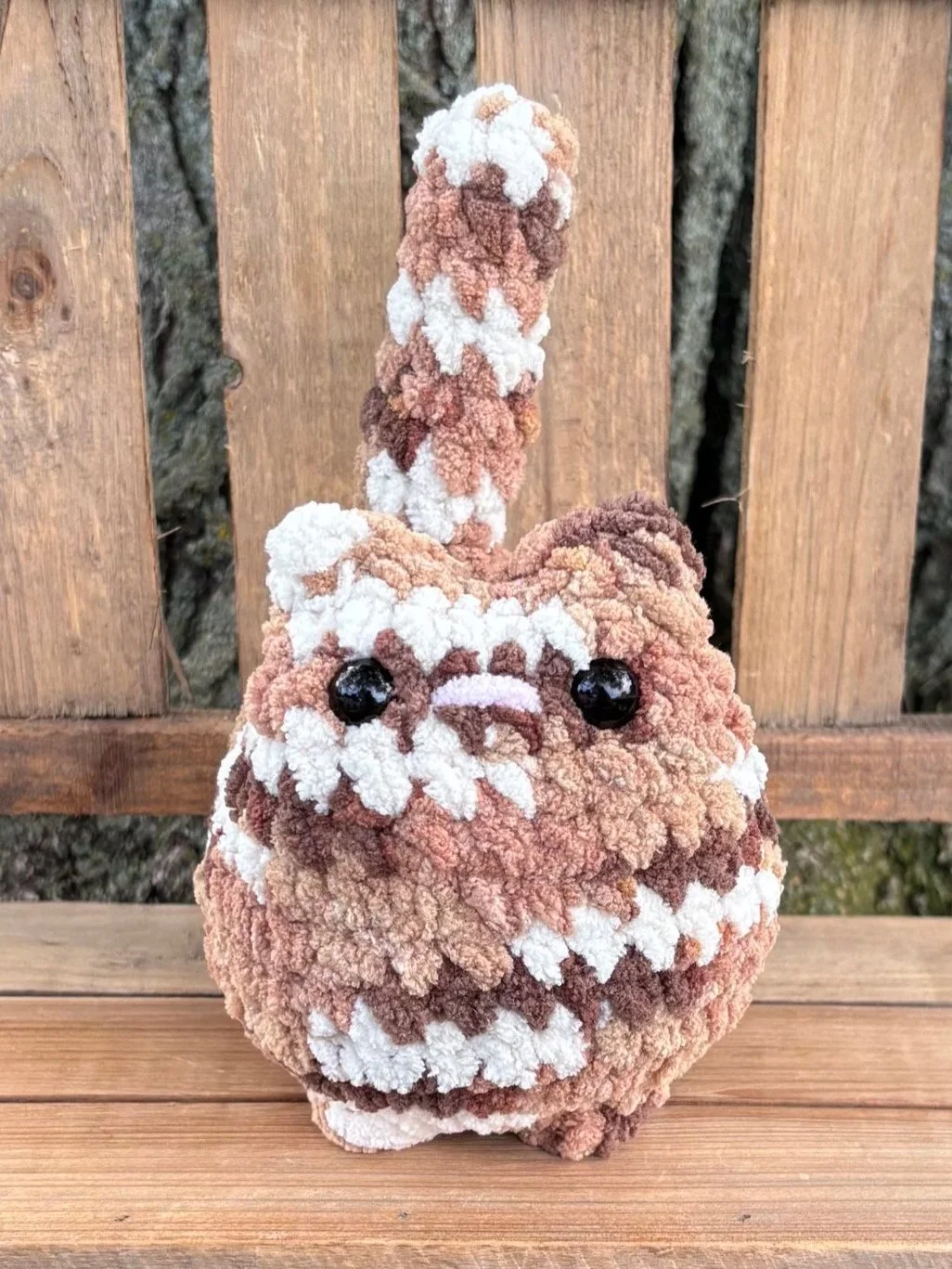 Close up of crochet tabby cat plushie face