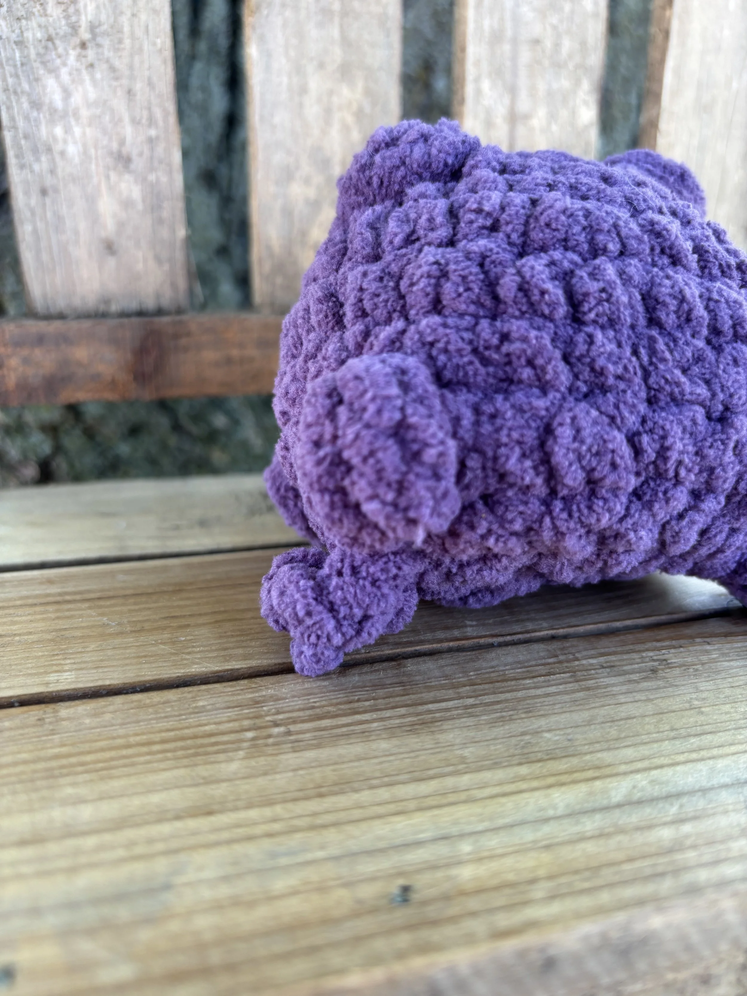 Close up of crochet jumping frog plushie leg