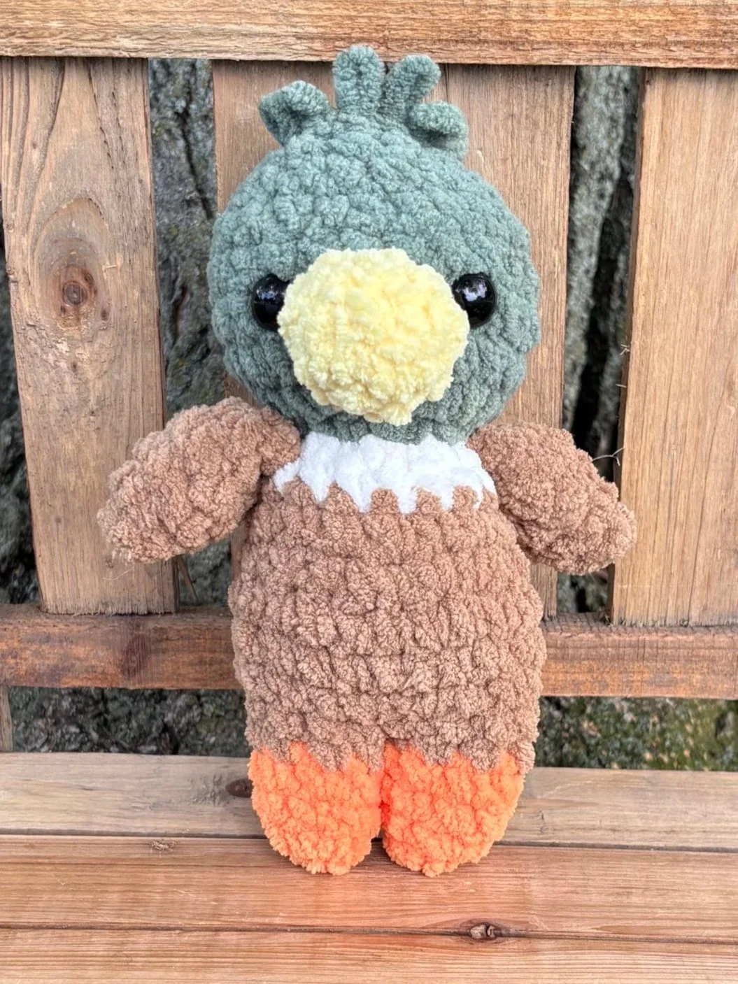 Close up of crochet mallard duck plushie face