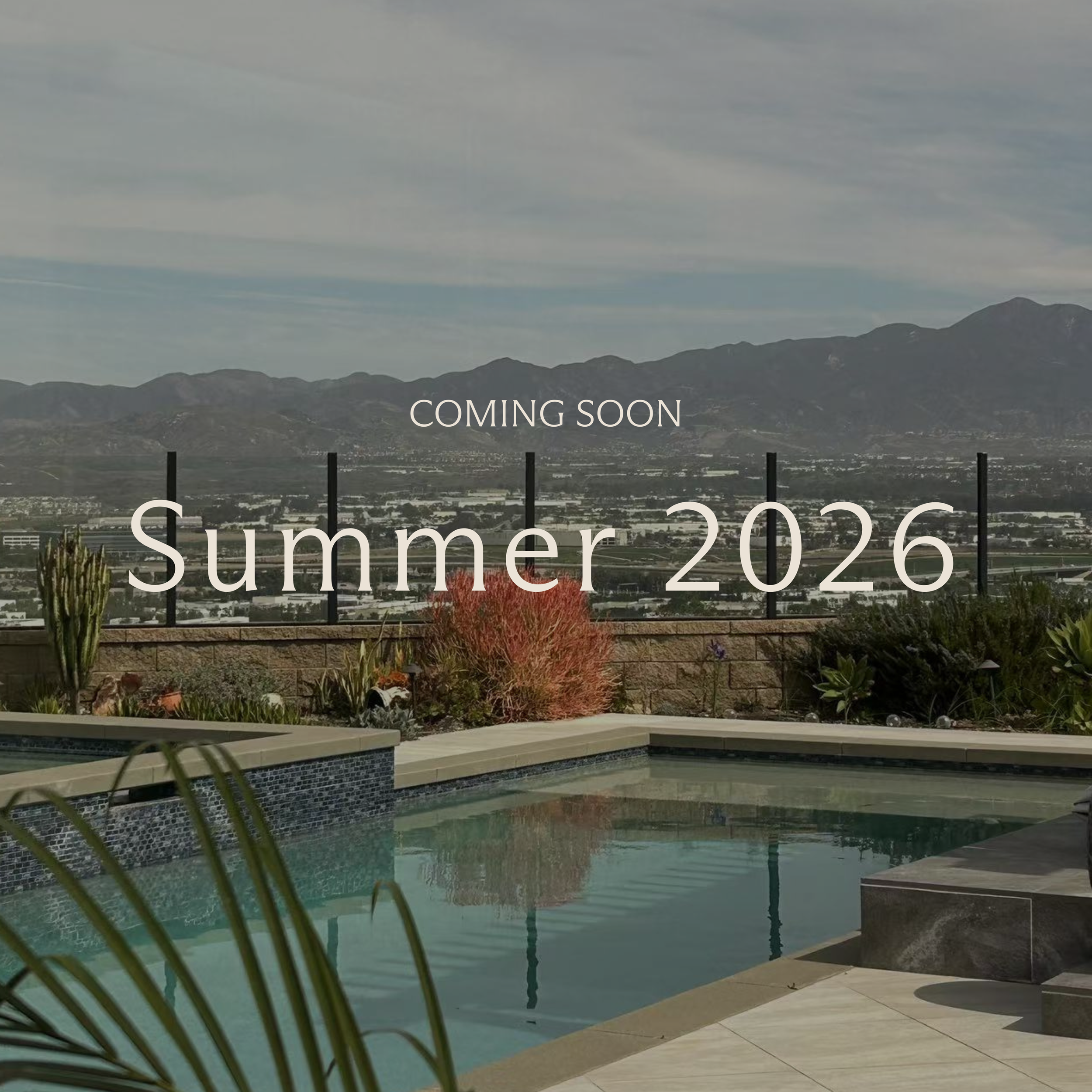 Pool area with plants and mountain view, text overlay 'Coming Soon Summer 2026' Interior design luxury residential project in Irvine California
