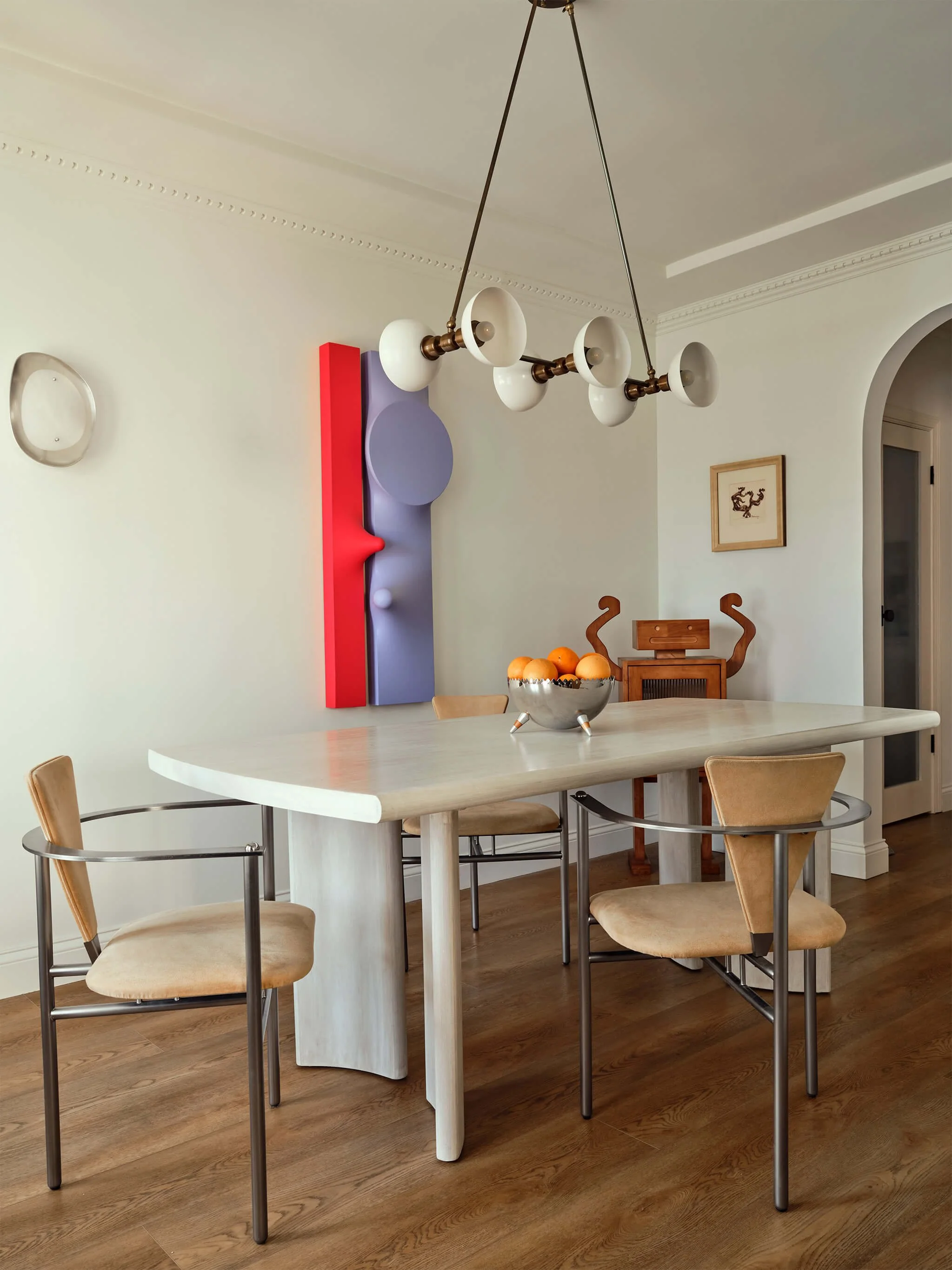 Dining room paired with vintage chairs and Samantha McCurdy's sculptural artwork
