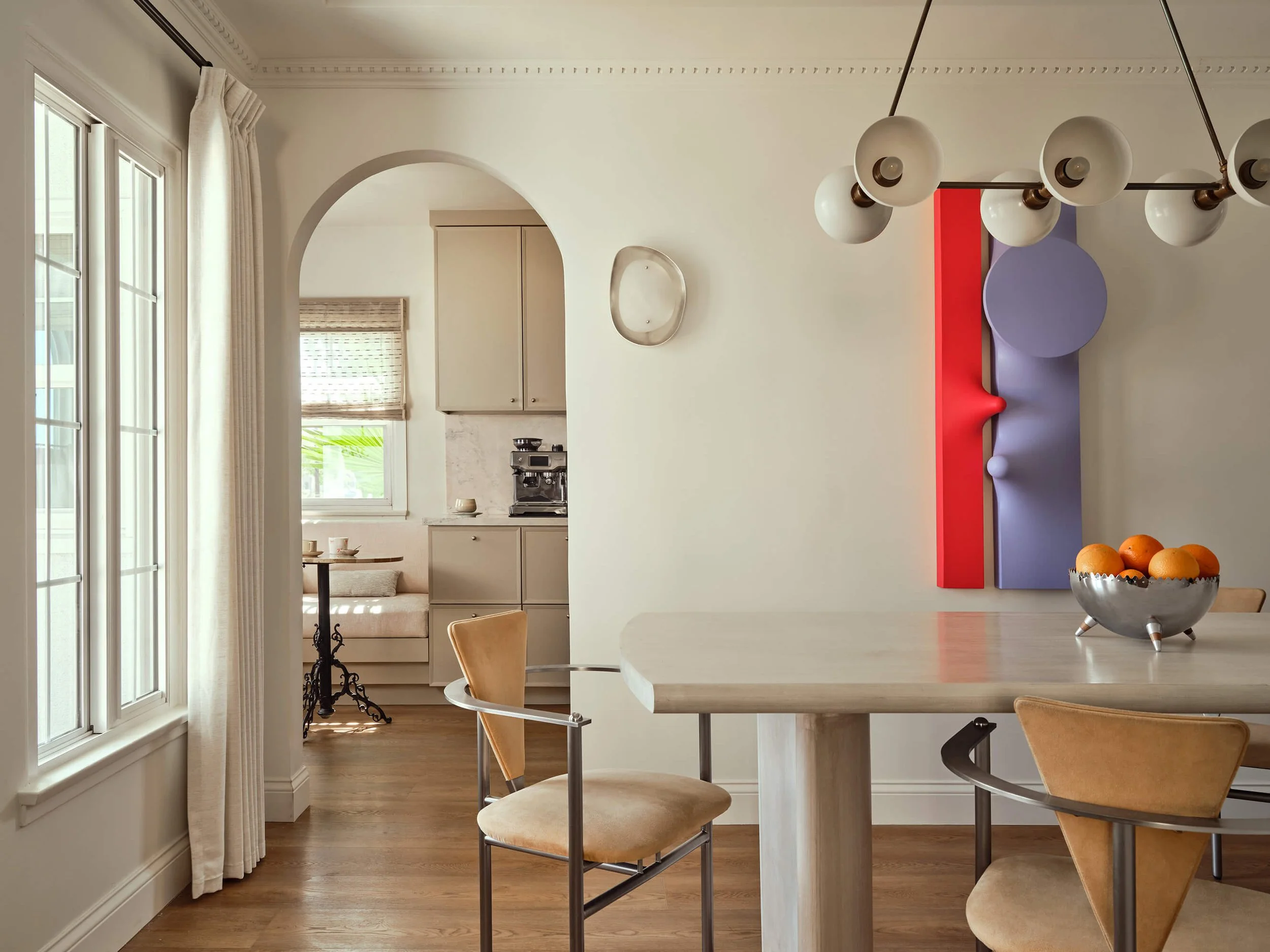 Dining room paired with vintage chairs and Samantha McCurdy's sculptural artwork