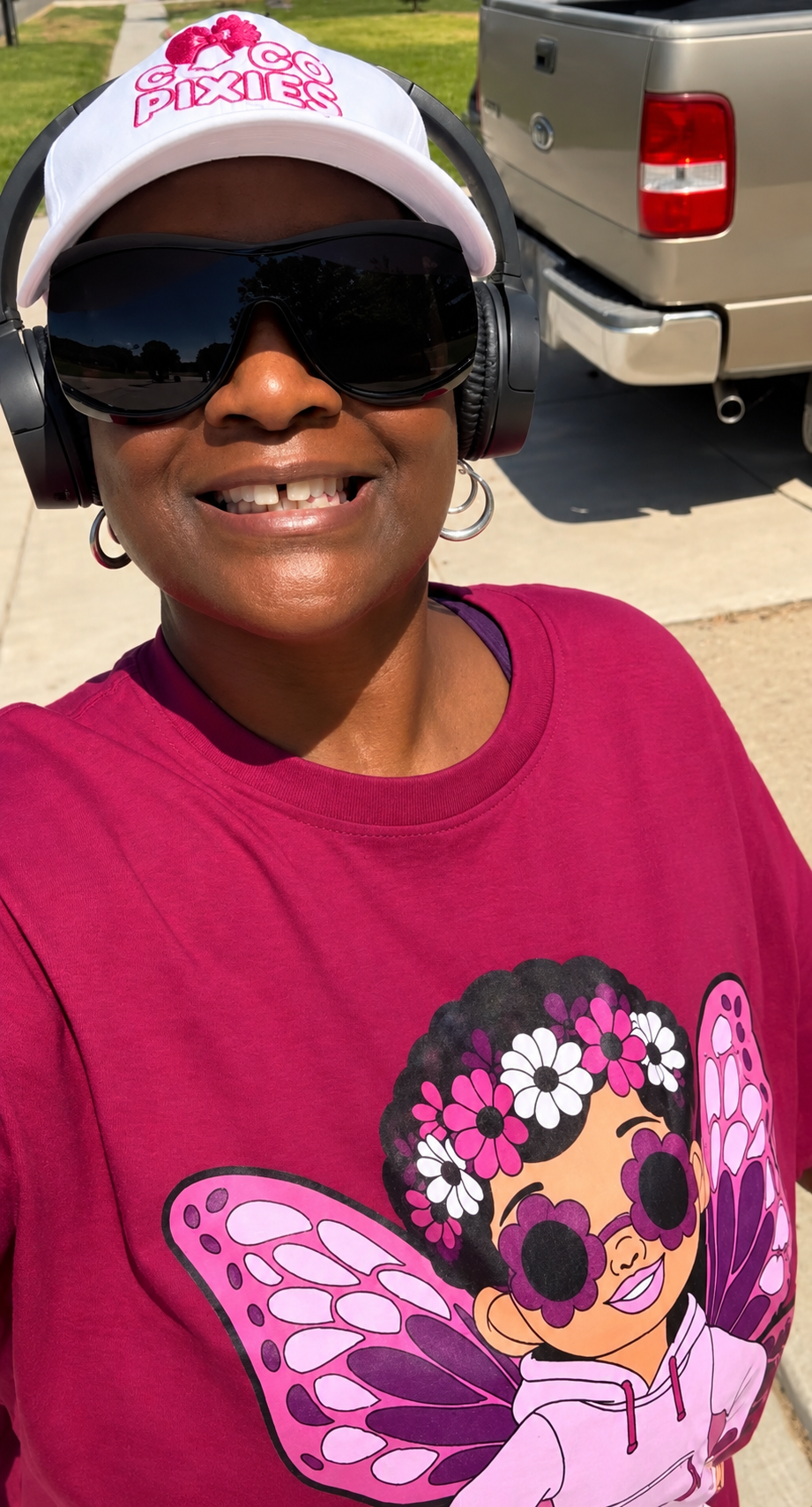Black woman walking while wearing her Coco Pixies Embroidered Logo Hat - White with Pink Logo