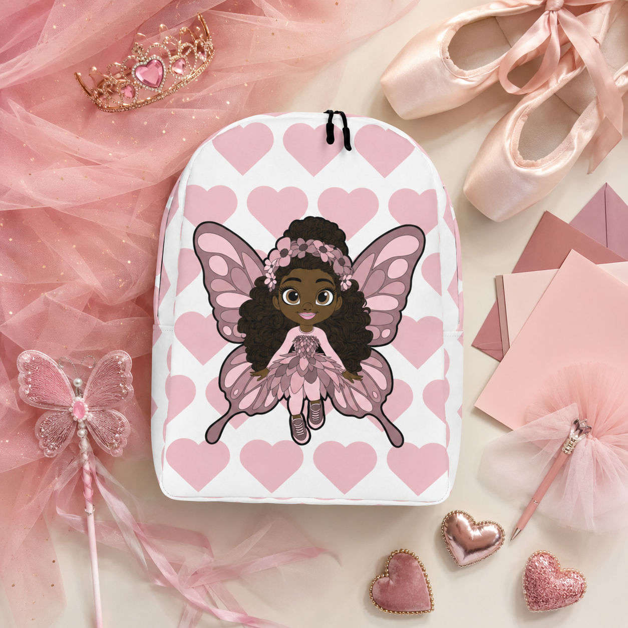 Coco Pixies Penelope Pixie Backpack featuring a Black girl character and blush pink hearts on a white background