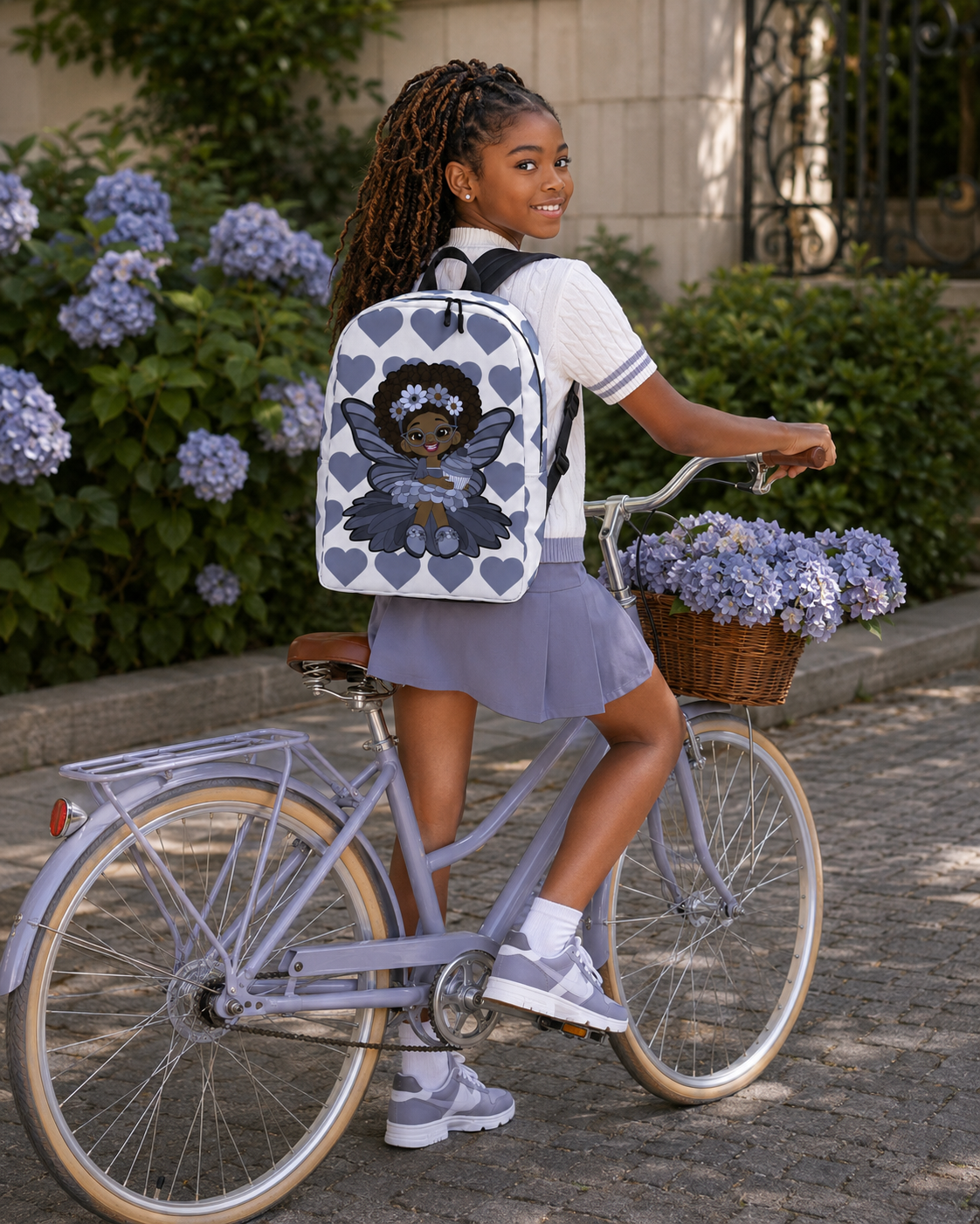 Bubbly Brooke Pixie Backpack by Coco Pixies with a Black girl pixie, cupcake and slate-blue signature heart pattern