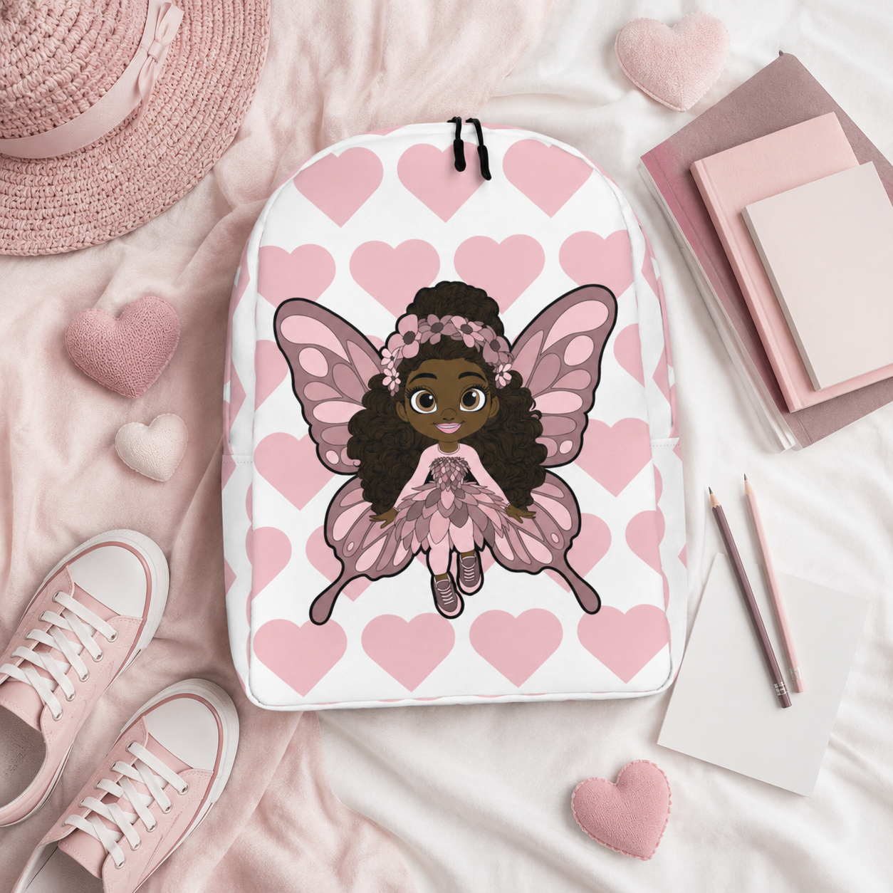 Coco Pixies Penelope Pixie Backpack featuring a Black girl character and blush pink hearts on a white background