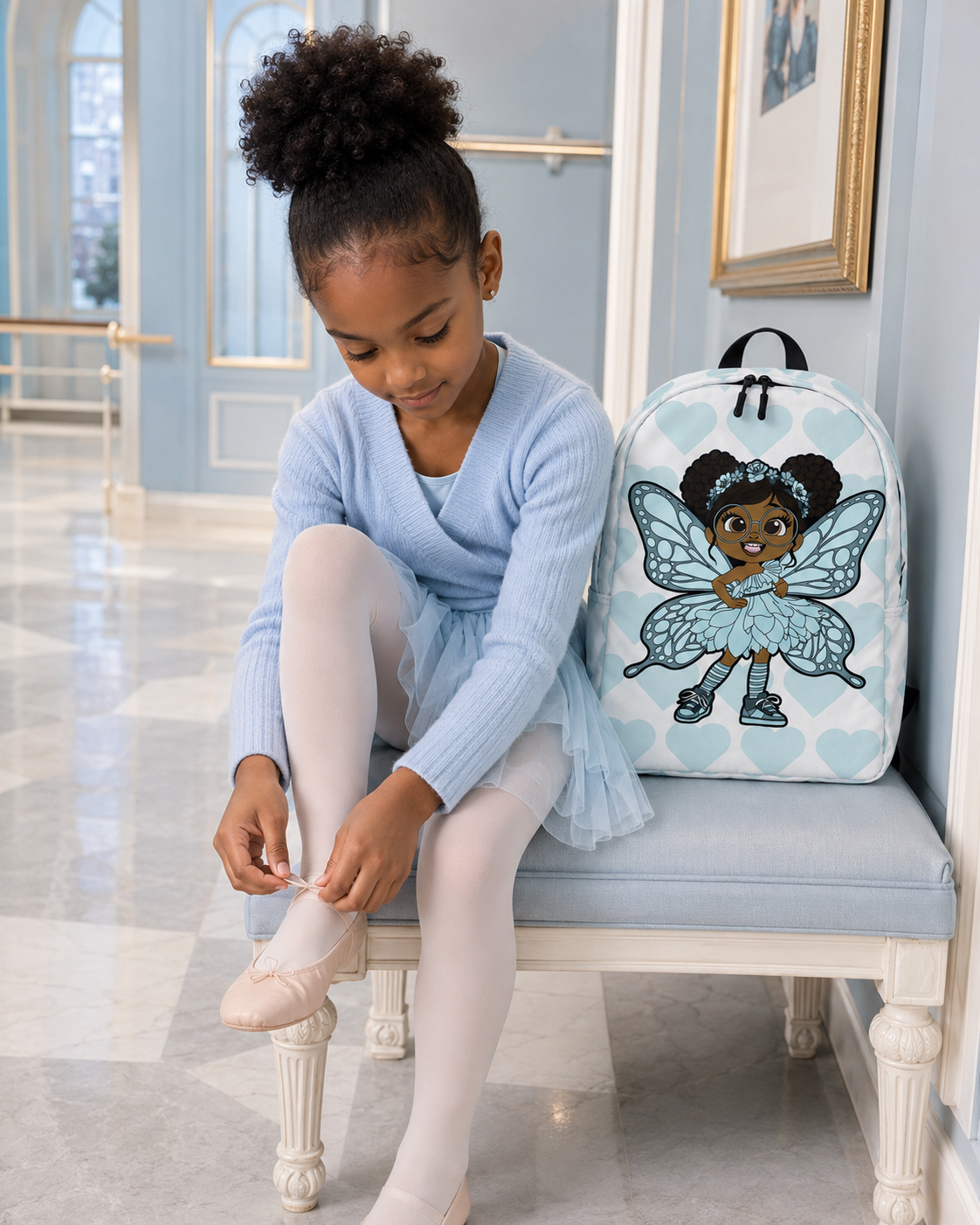 Coco Pixies JoJo Jollypuff backpack featuring afro puffs, glasses, aqua wings, and heart-patterned design
