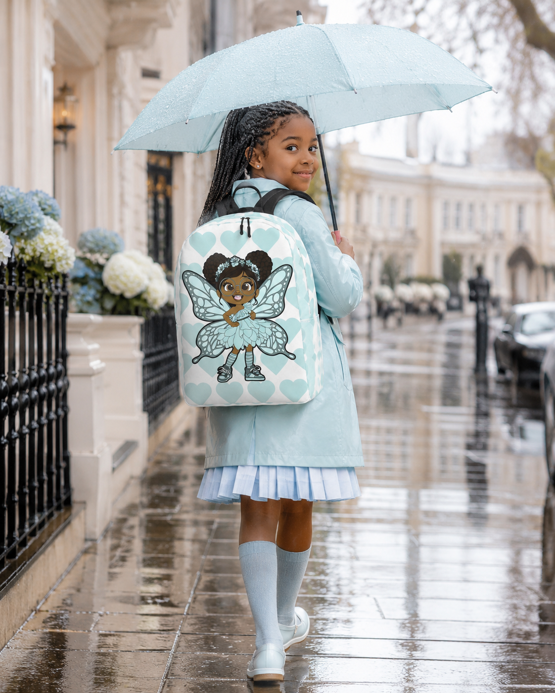 Coco Pixies JoJo Jollypuff backpack featuring afro puffs, glasses, aqua wings, and heart-patterned design