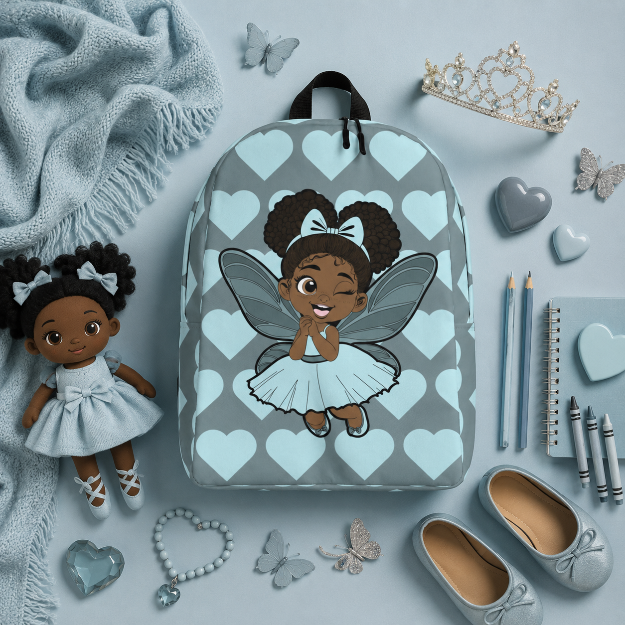 Gleeful Grace Pixie Backpack by Coco Pixies with icy blue hearts, afro puffs, wings, and gray background