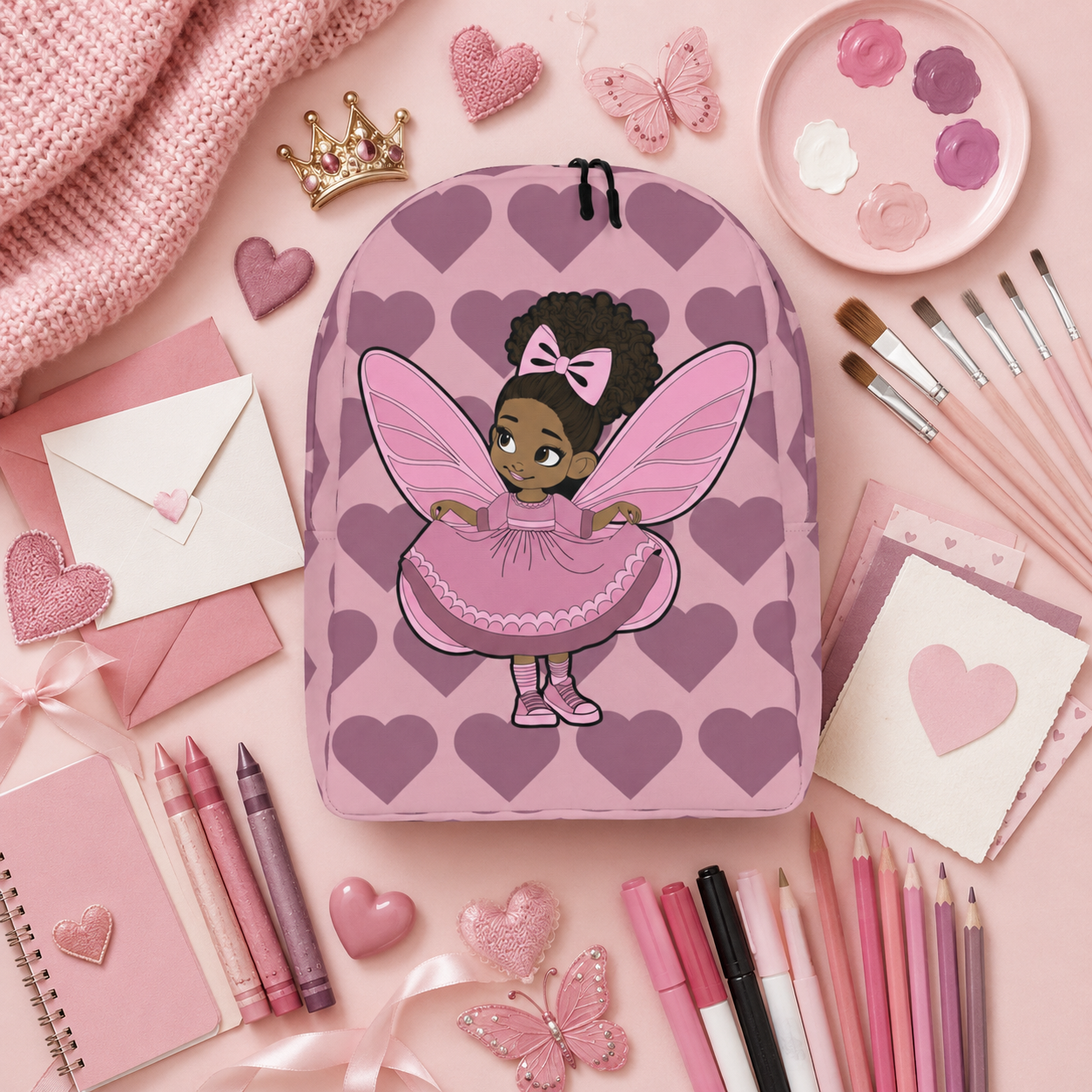 Coco Pixies Darling Daphne backpack with a curly afro puff character, pink wings and mauve hearts.