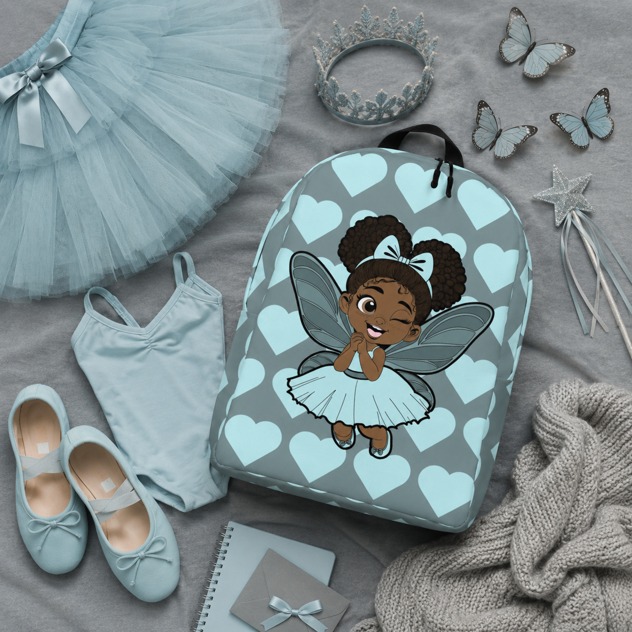 Gleeful Grace Pixie Backpack by Coco Pixies with icy blue hearts, afro puffs, wings, and gray background