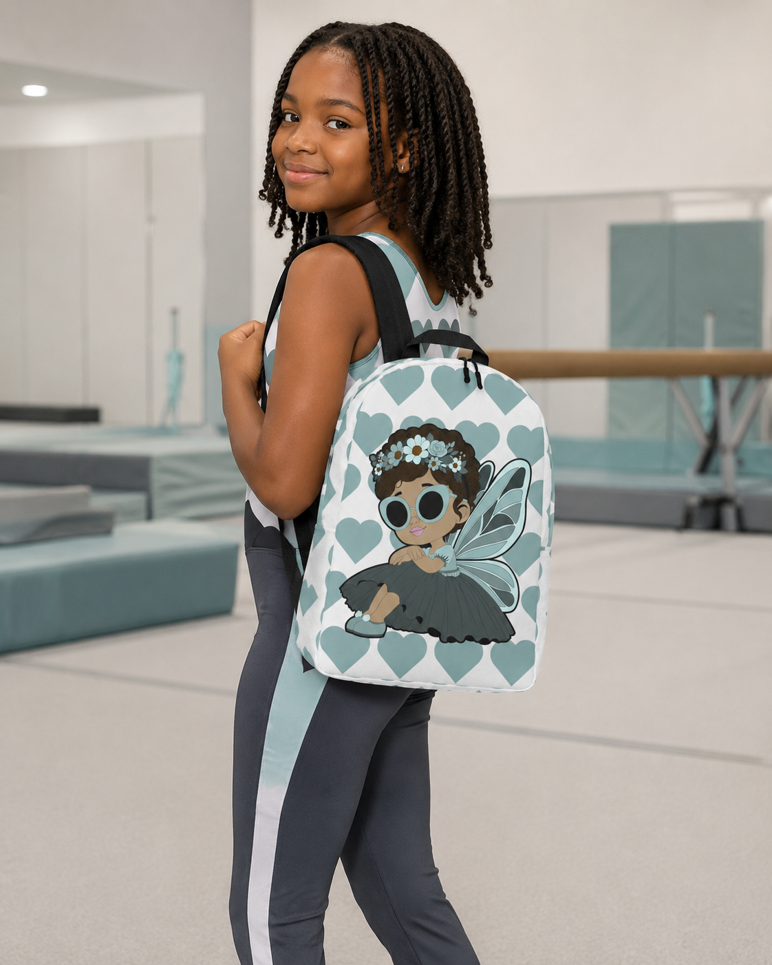 Coco Pixies Pixie Piper Backpack featuring a Black girl pixie, aqua hearts, sunglasses, and floral details