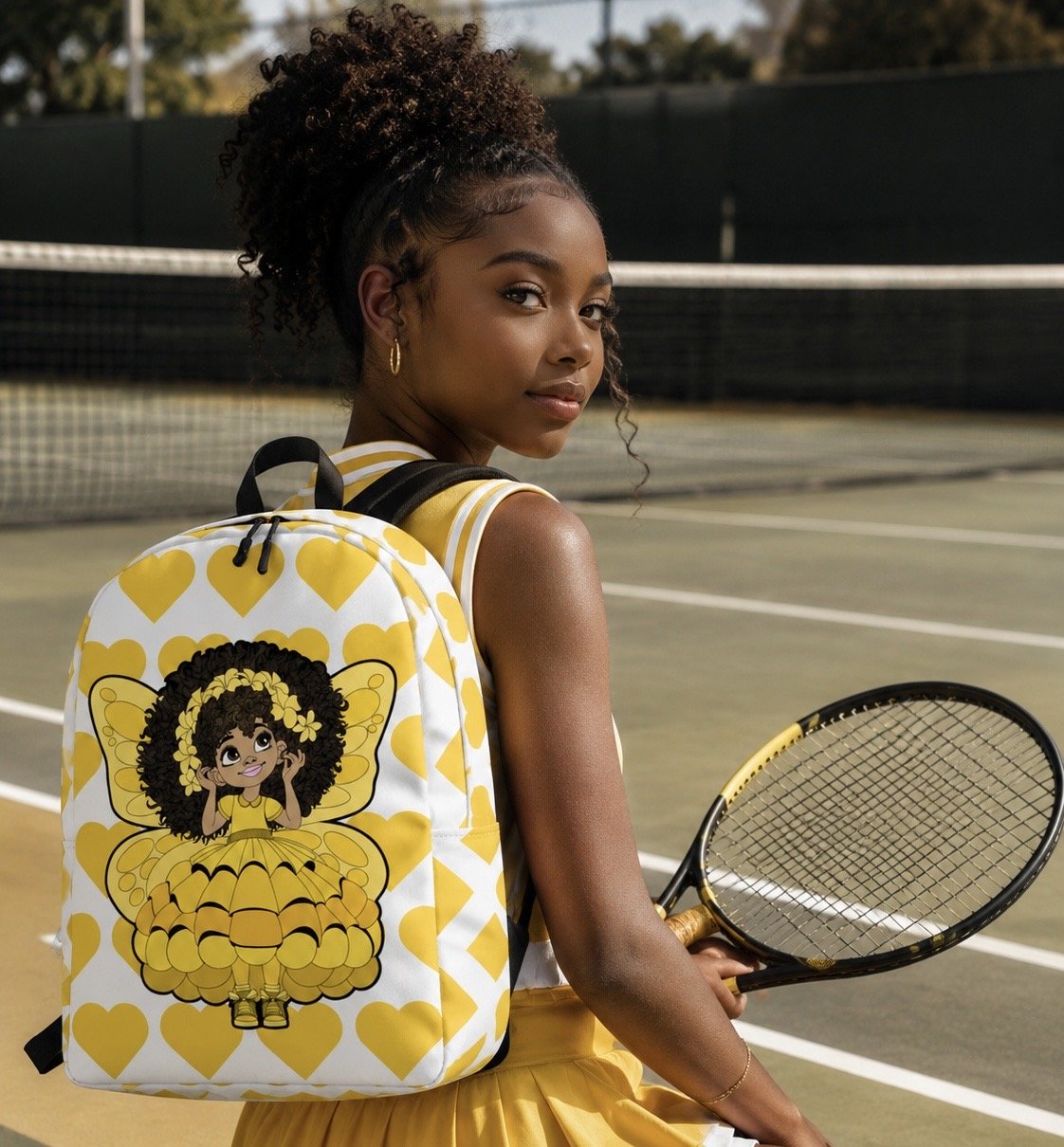 Blissful Brandie Pixie Backpack by Coco Pixies with a Black girl pixie, yellow wings and signature yellow heart pattern