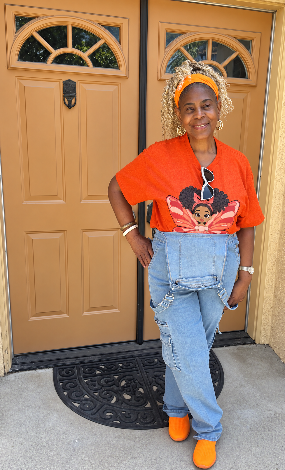 Black woman standing in front of her house posing  for a picture wearing her Lovely Layla Pixie Signature Shirt - Coco Pixies Character Graphic T-Shirt, ADULT SIZE