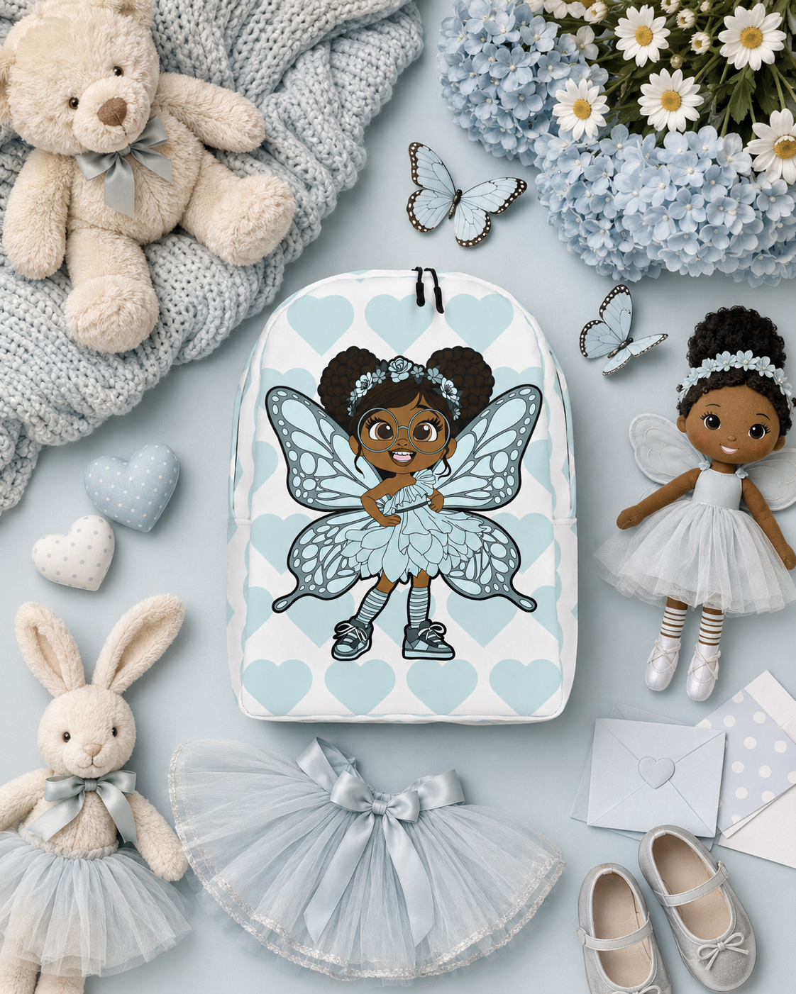 Coco Pixies JoJo Jollypuff backpack featuring afro puffs, glasses, aqua wings, and heart-patterned design