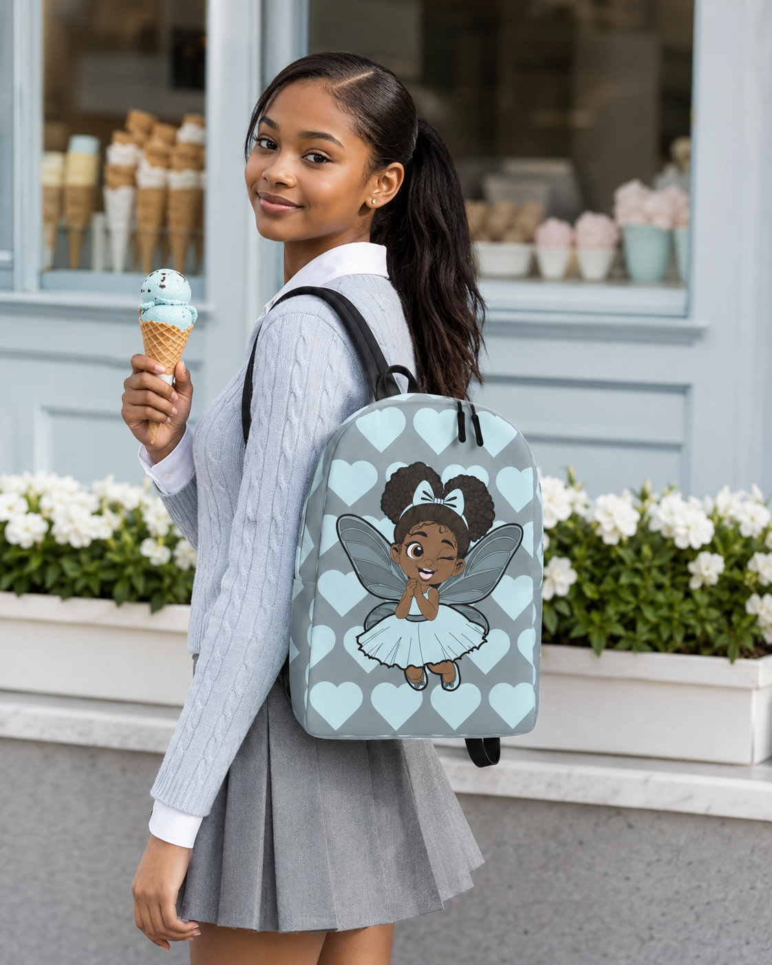 Gleeful Grace Pixie Backpack by Coco Pixies with icy blue hearts, afro puffs, wings, and gray background