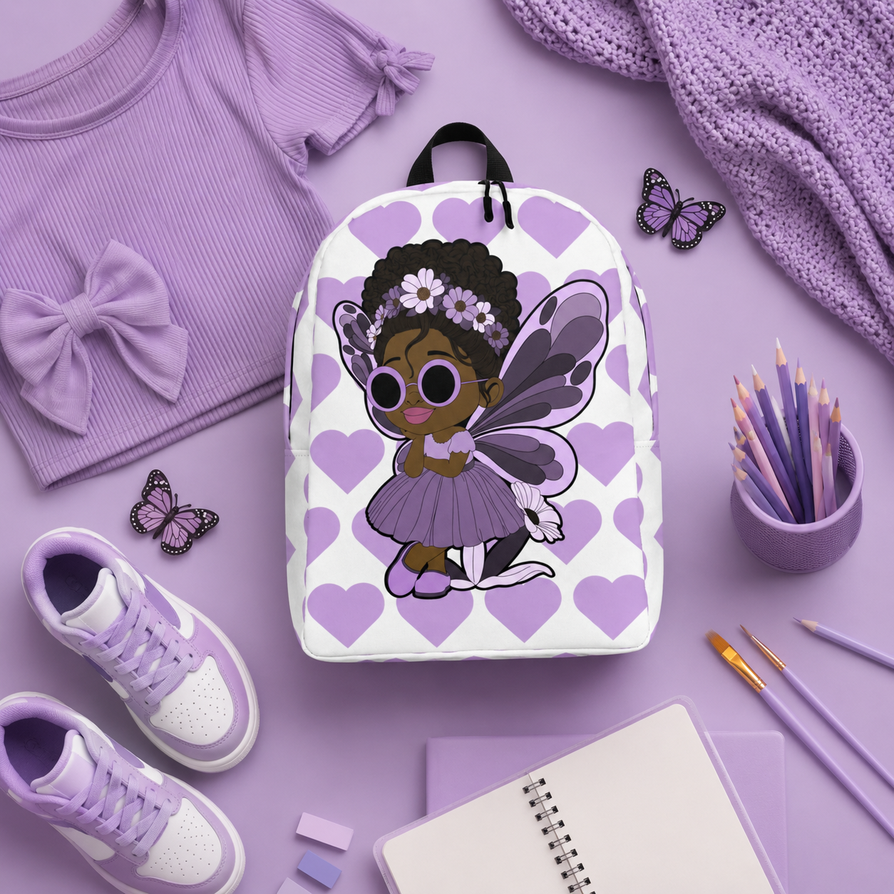 Coco Pixies Marvelous Mia girls backpack featuring a Black pixie with an afro puff, floral crown and purple butterfly wings