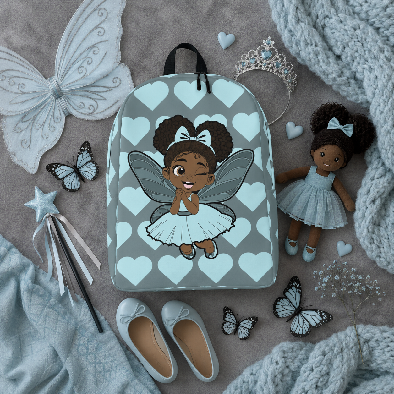 Gleeful Grace Pixie Backpack by Coco Pixies with icy blue hearts, afro puffs, wings, and gray background