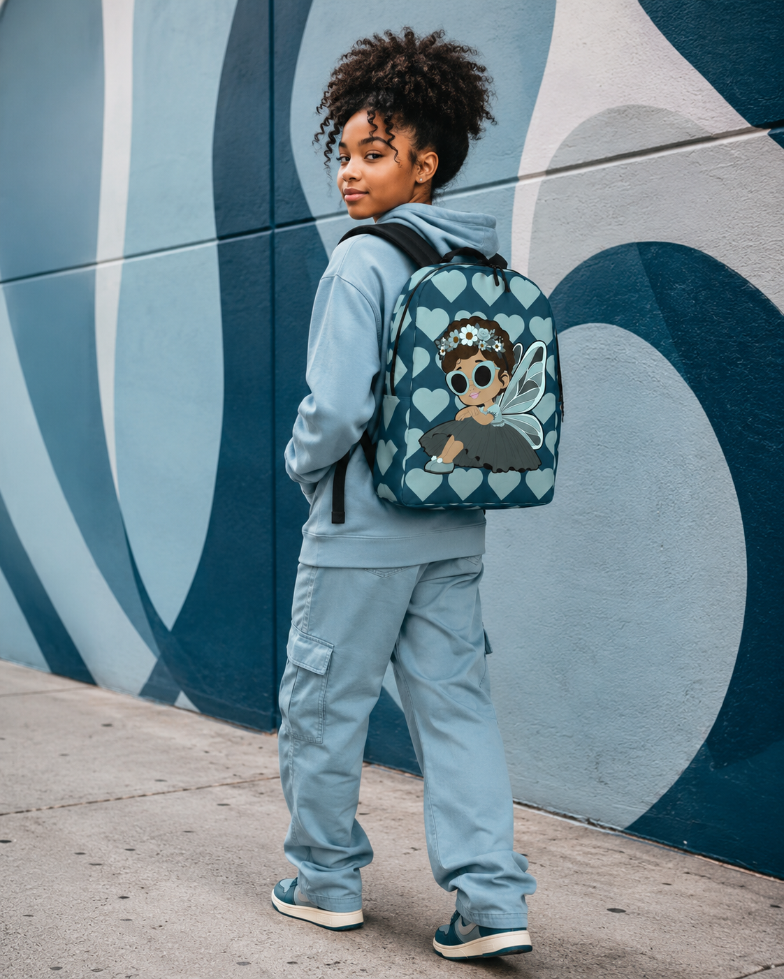 Coco Pixies Pixie Piper Backpack featuring aqua teal hearts, curly hair, sunglasses, and detailed pixie wings