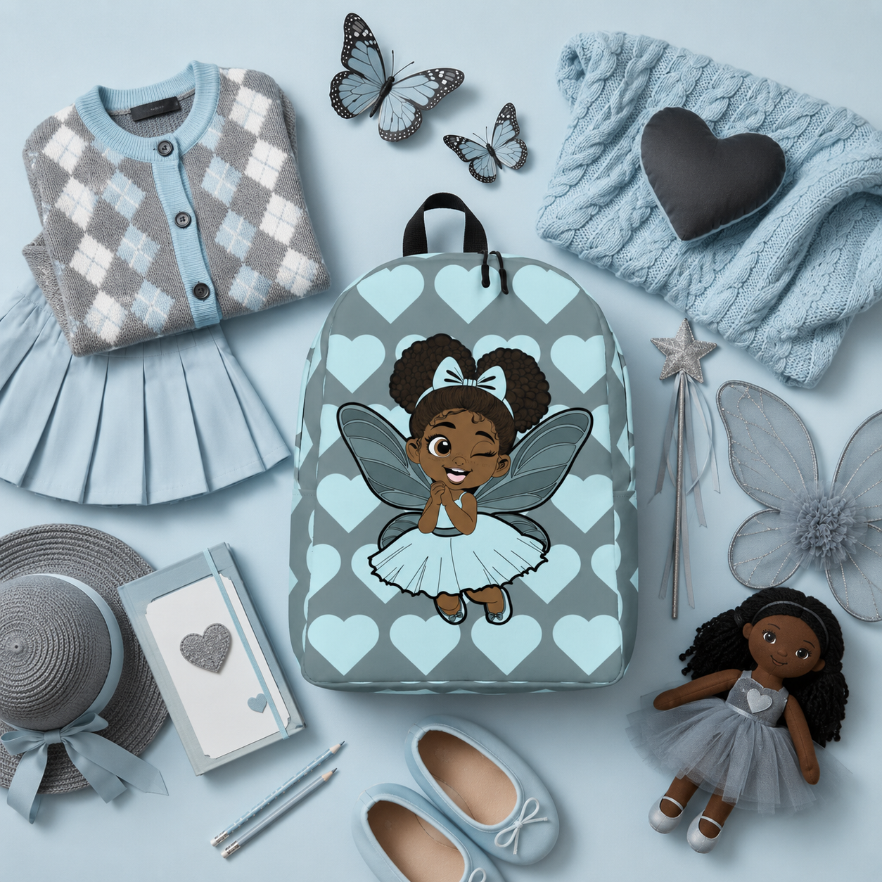 Gleeful Grace Pixie Backpack by Coco Pixies with icy blue hearts, afro puffs, wings, and gray background