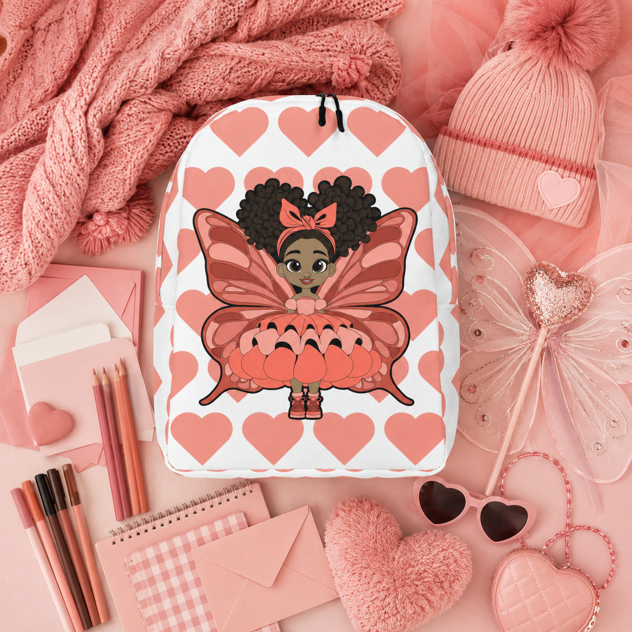 Coco Pixies Lovely Layla children’s backpack featuring a Black girl pixie and coral Signature Heart Pattern