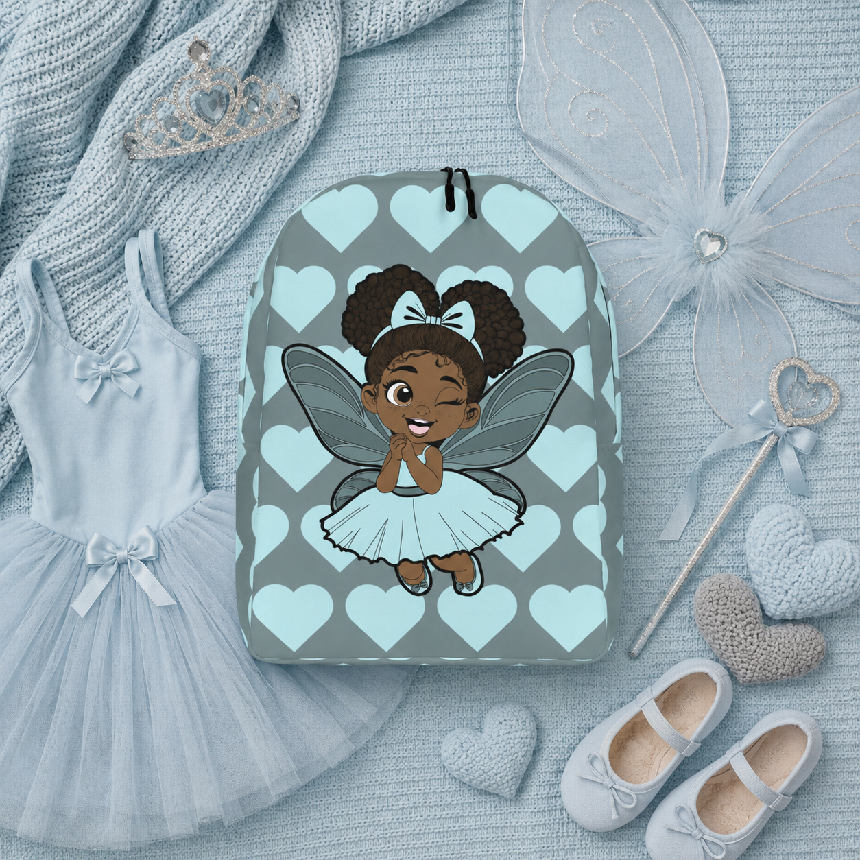 Gleeful Grace Pixie Backpack by Coco Pixies with icy blue hearts, afro puffs, wings, and gray background