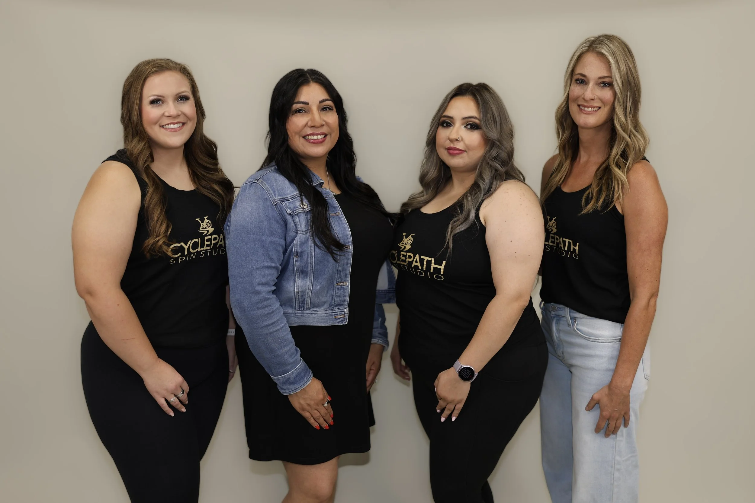 Group photo of owner Rita and some of her spin instructors