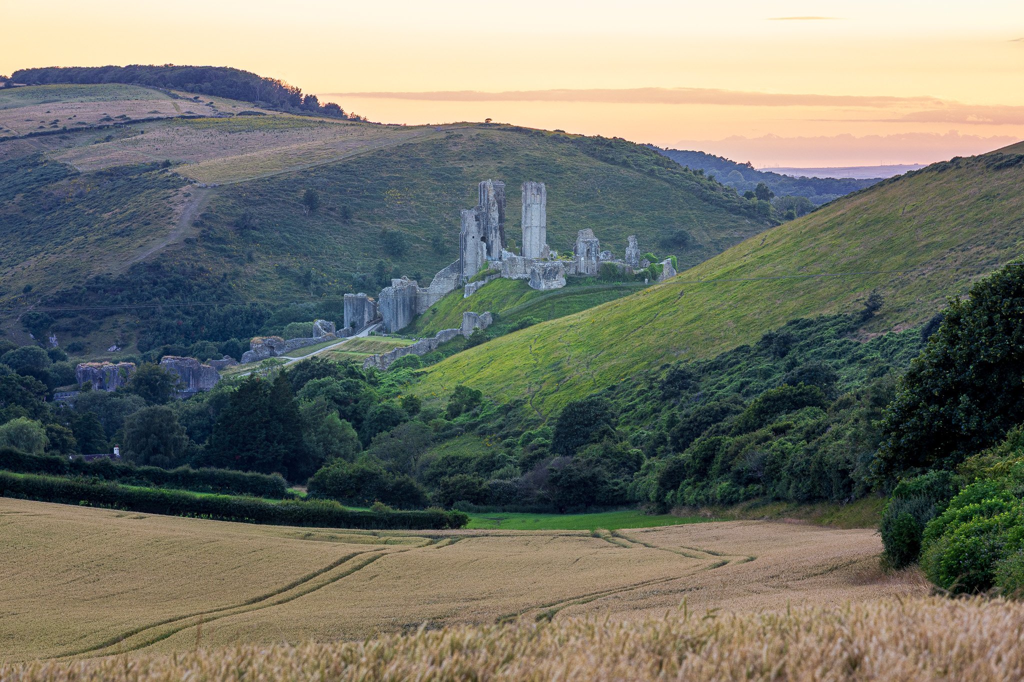 Corfe Castle nestled between Cahallows and West Hill along the chalk Purbeck ridge