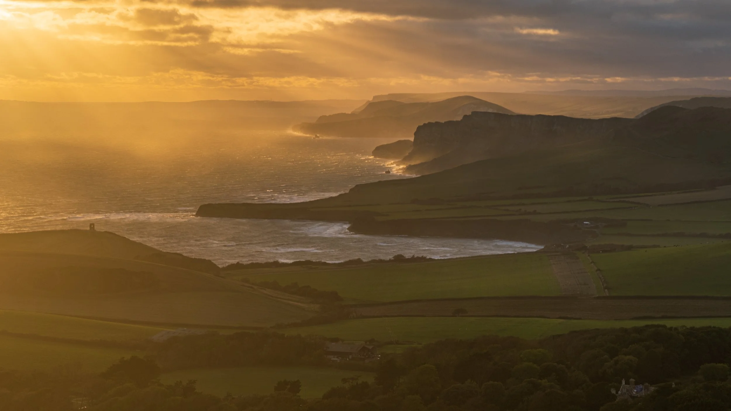 Stormy sunset looking from Swyre Head towards Kimmeridge - Clavell Tower on the left hand side