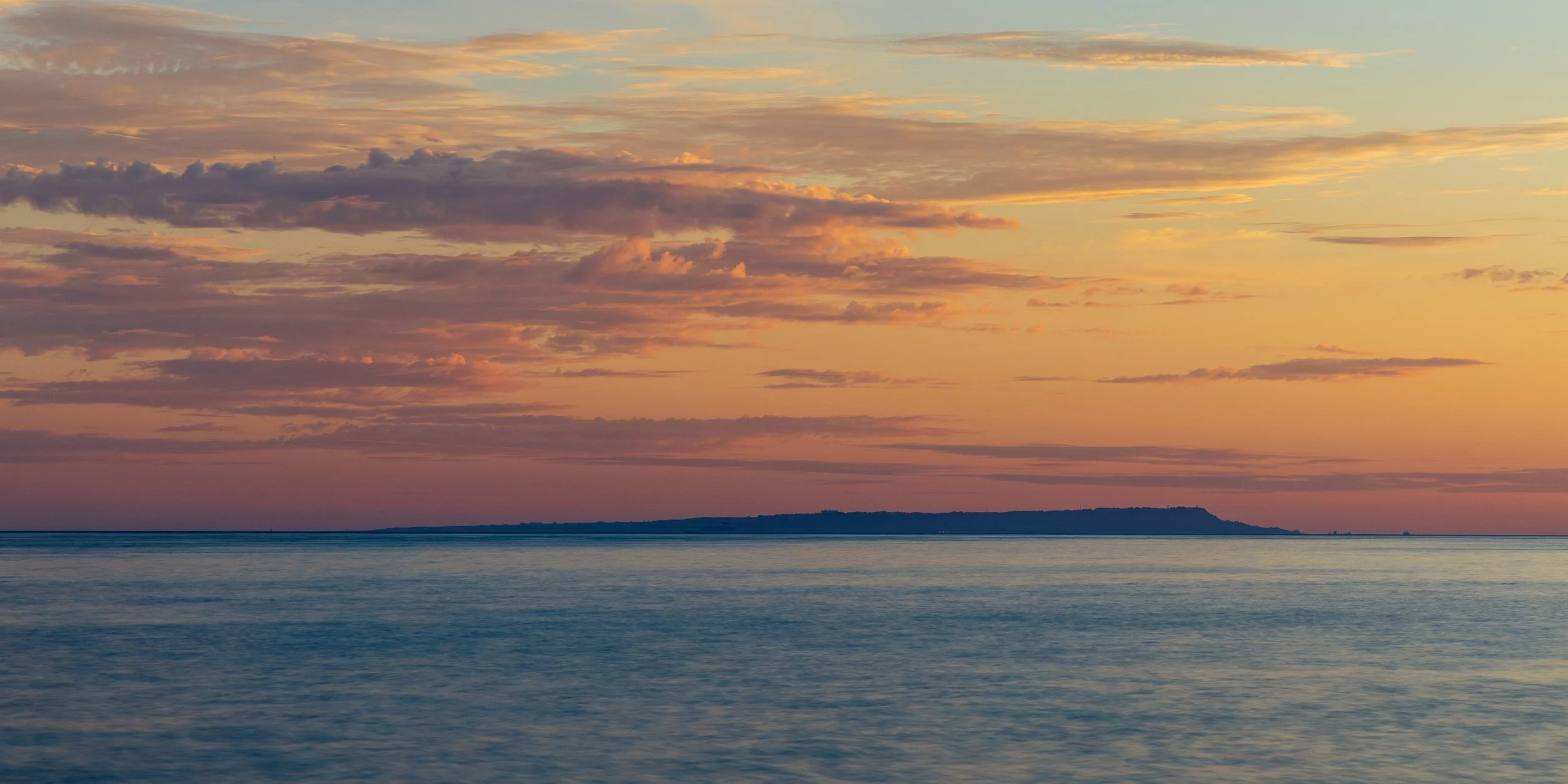 Sunset from above Chapmans Poole looking towards Portland in the distance