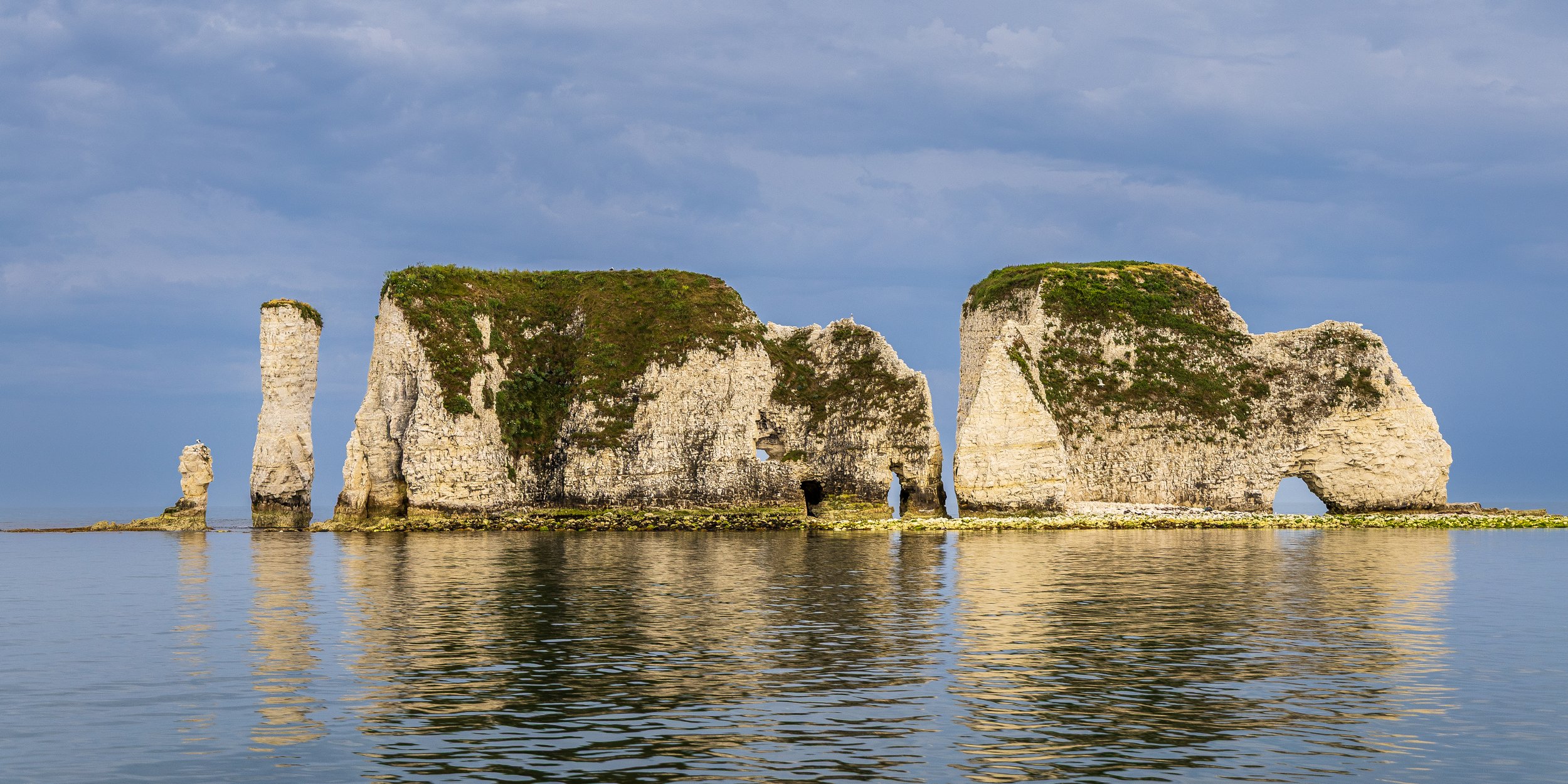 Old Harry Rocks from the water - looking dramatic against a sky filled with an incoming thunderstorm