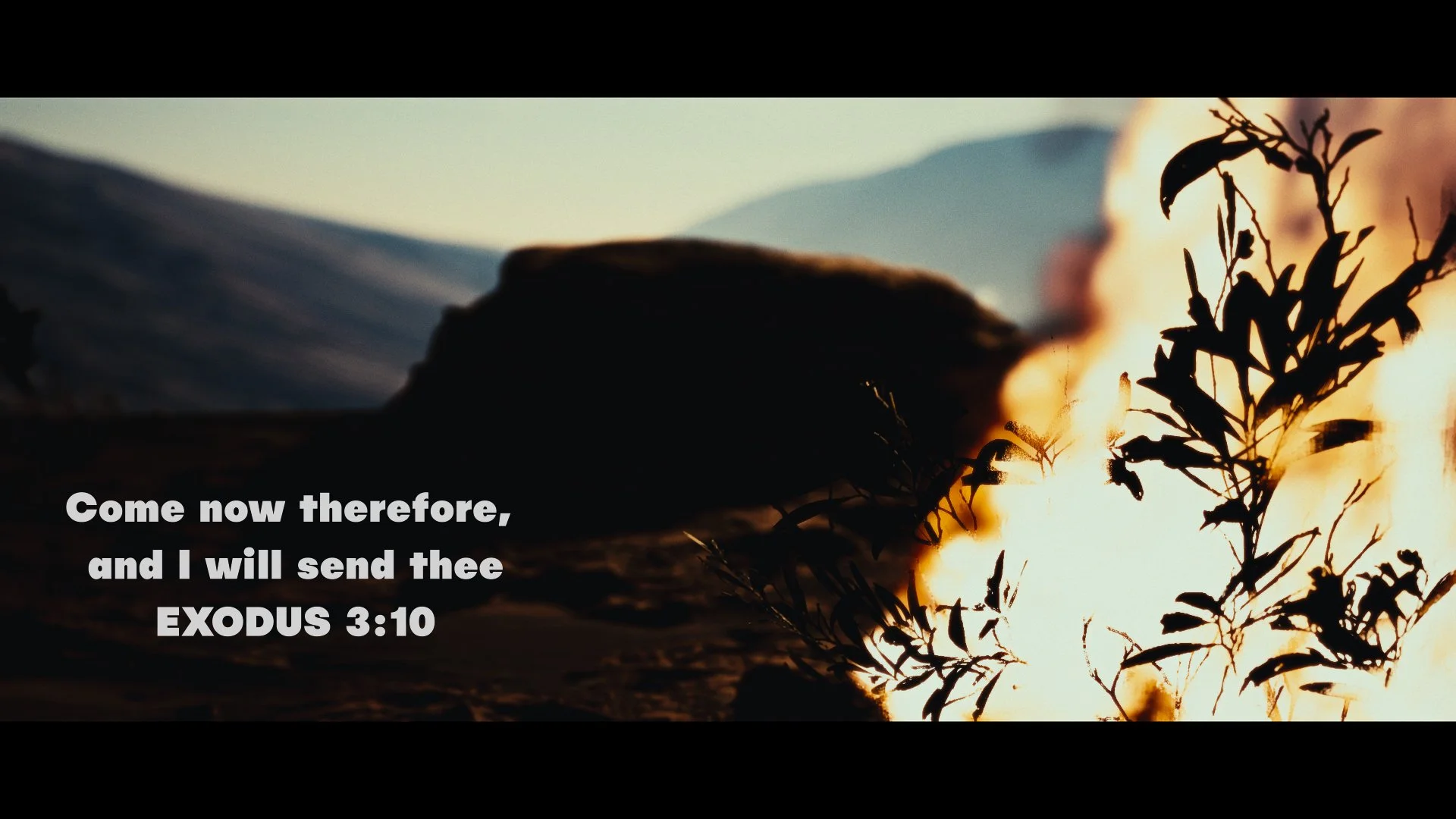 The burning bush in flames beside a rock outcrop in the Sinai wilderness with Exodus 3:10, sermon intro video for church