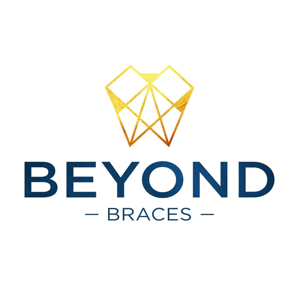 Logo for Beyond Braces featuring a geometric gold crown above the text 'BEYOND BRACES' in navy blue.