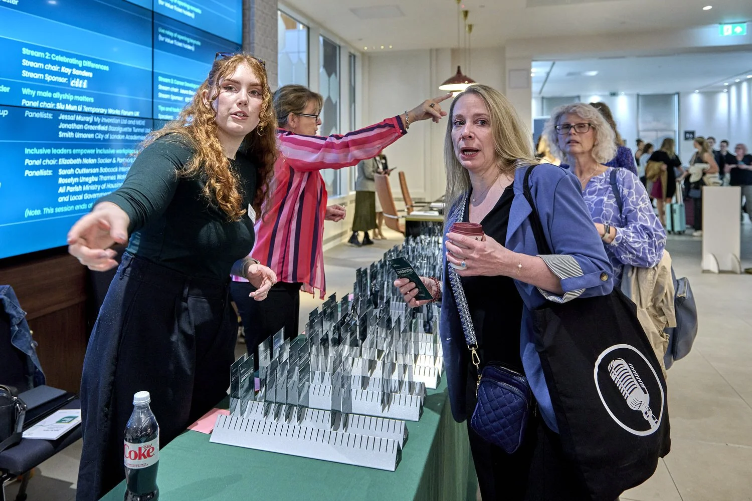 Reception desk at conference event filled with delegate badges.