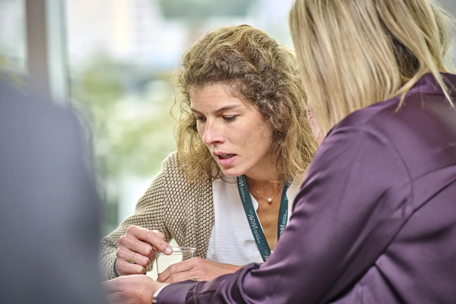 Lady at discussion table during networking session.