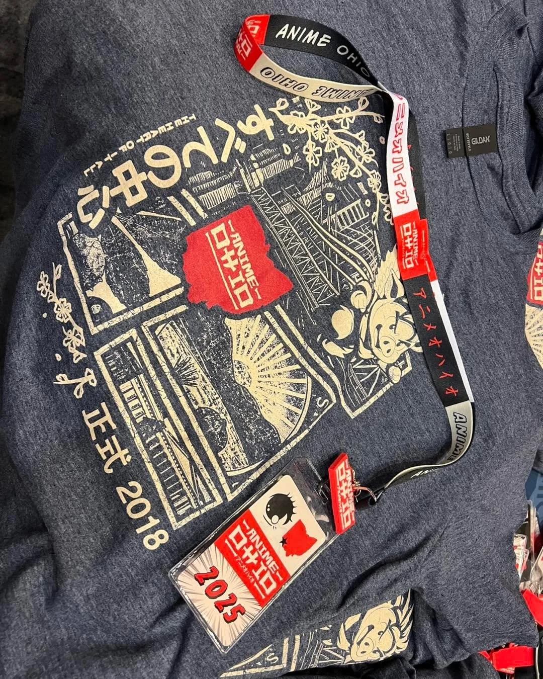Sunday is the last chance to get your Anime Ohio T-shirt in person!
Sizes range from S and XXL! They cost $20 and can be found at the merch booth in the ballroom!

With the purchase of a shirt, for $5 more, you can get a collectible Anime Ohio lanyar