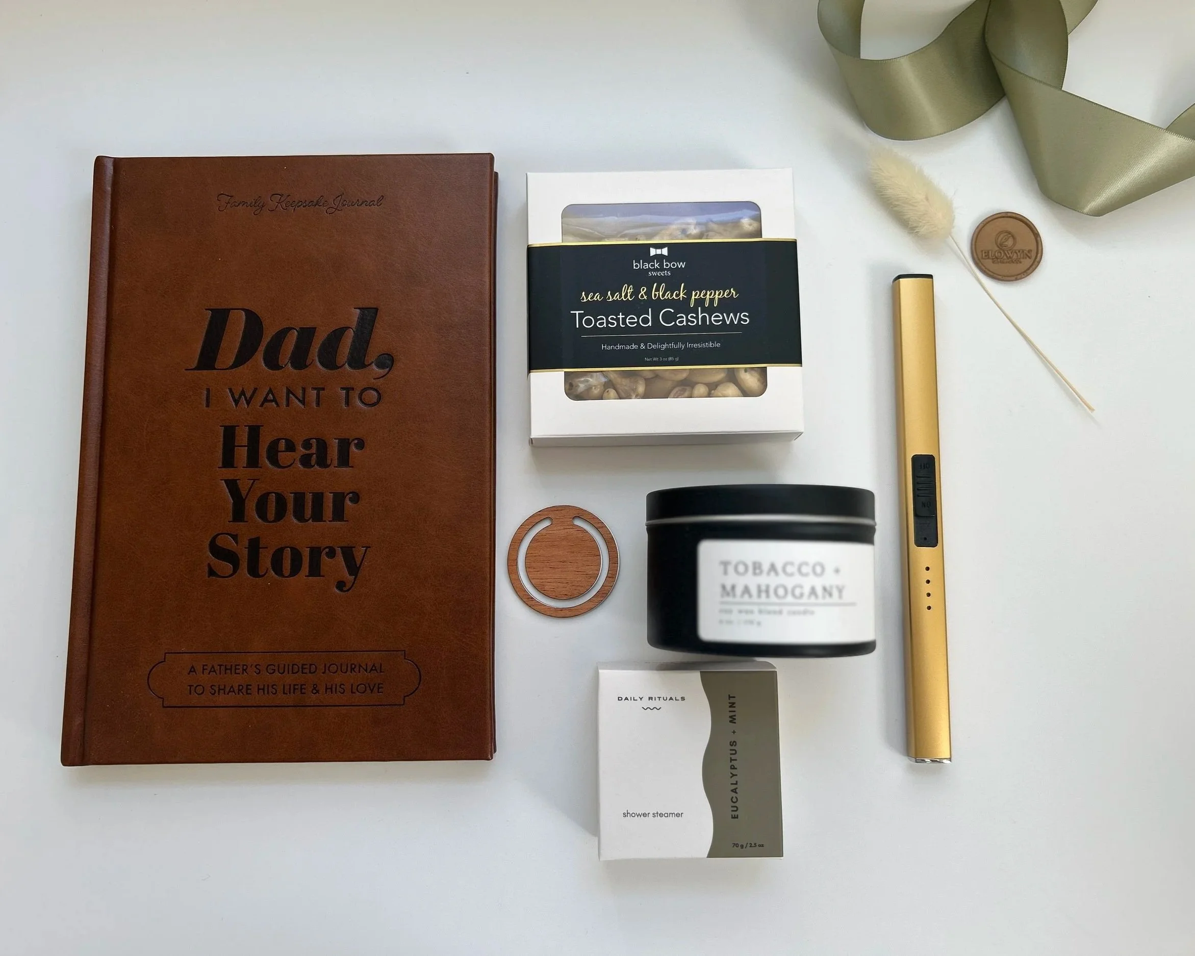 A gift box containing a blue pancake and waffle mix canister, a black candle labeled 'Sunday Brunch,' a bag of Trailblazer coffee, a jar of maple creamed honey, and a coffee cup, all arranged on shredded paper inside a wooden box.