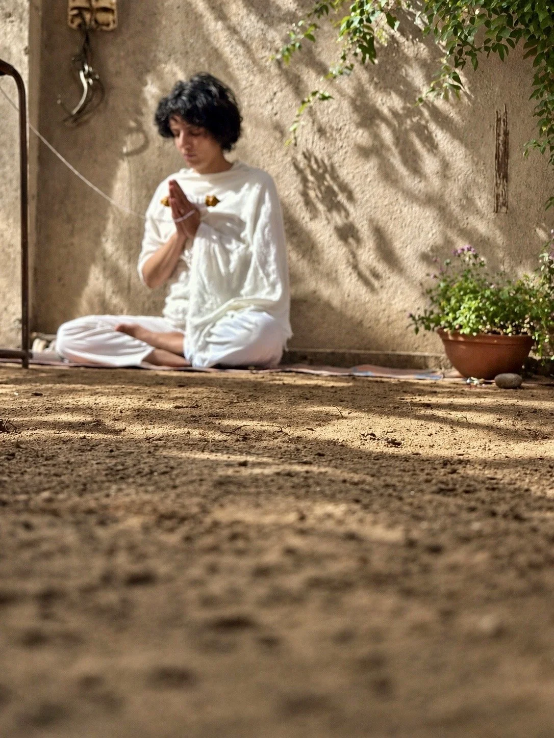 Shabnam Banihashem practising meditation outdoors in natural light, Shabnam Yoga Pembrokeshire UK