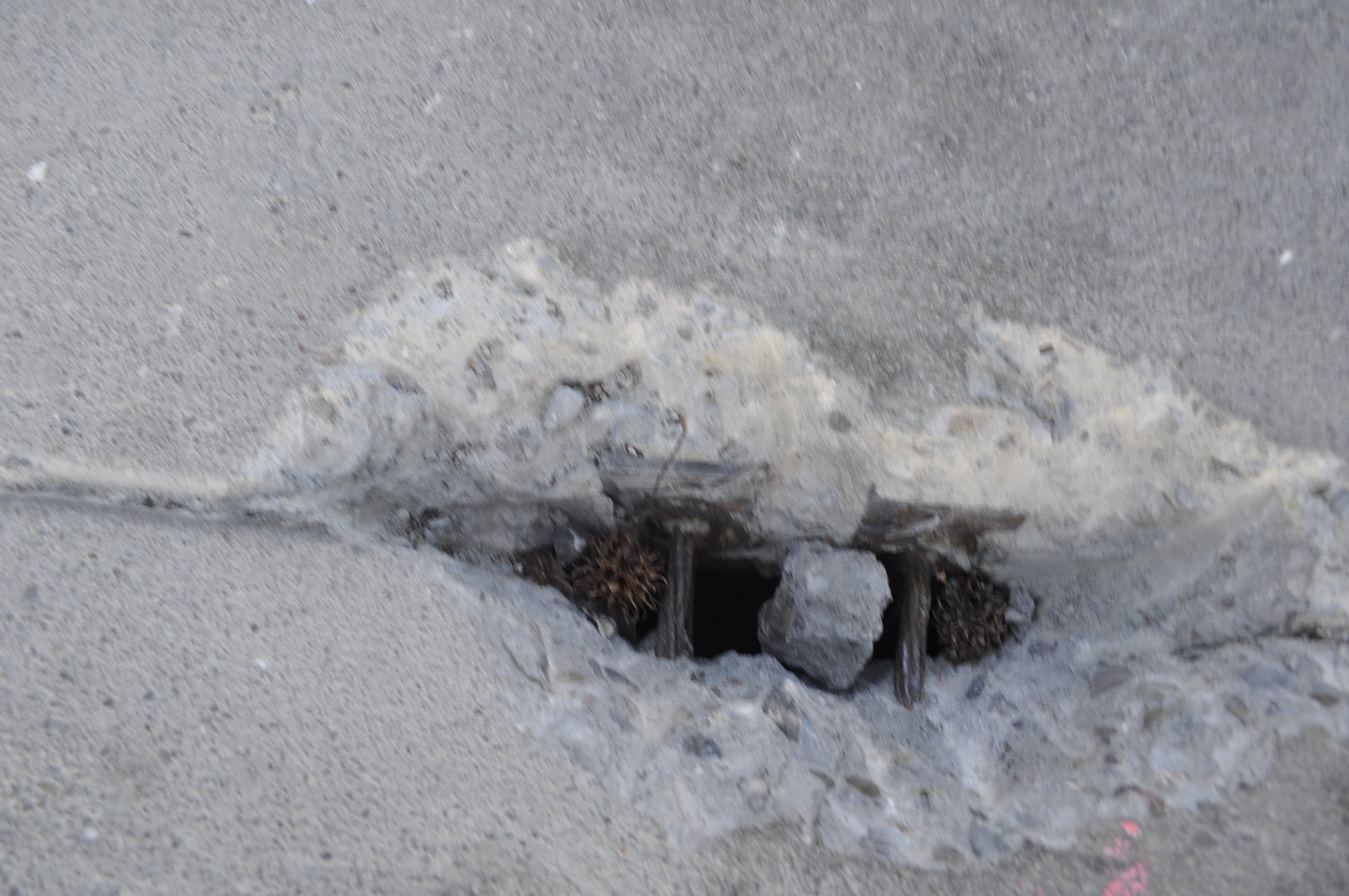 Concrete spall exposing post-tension tendons