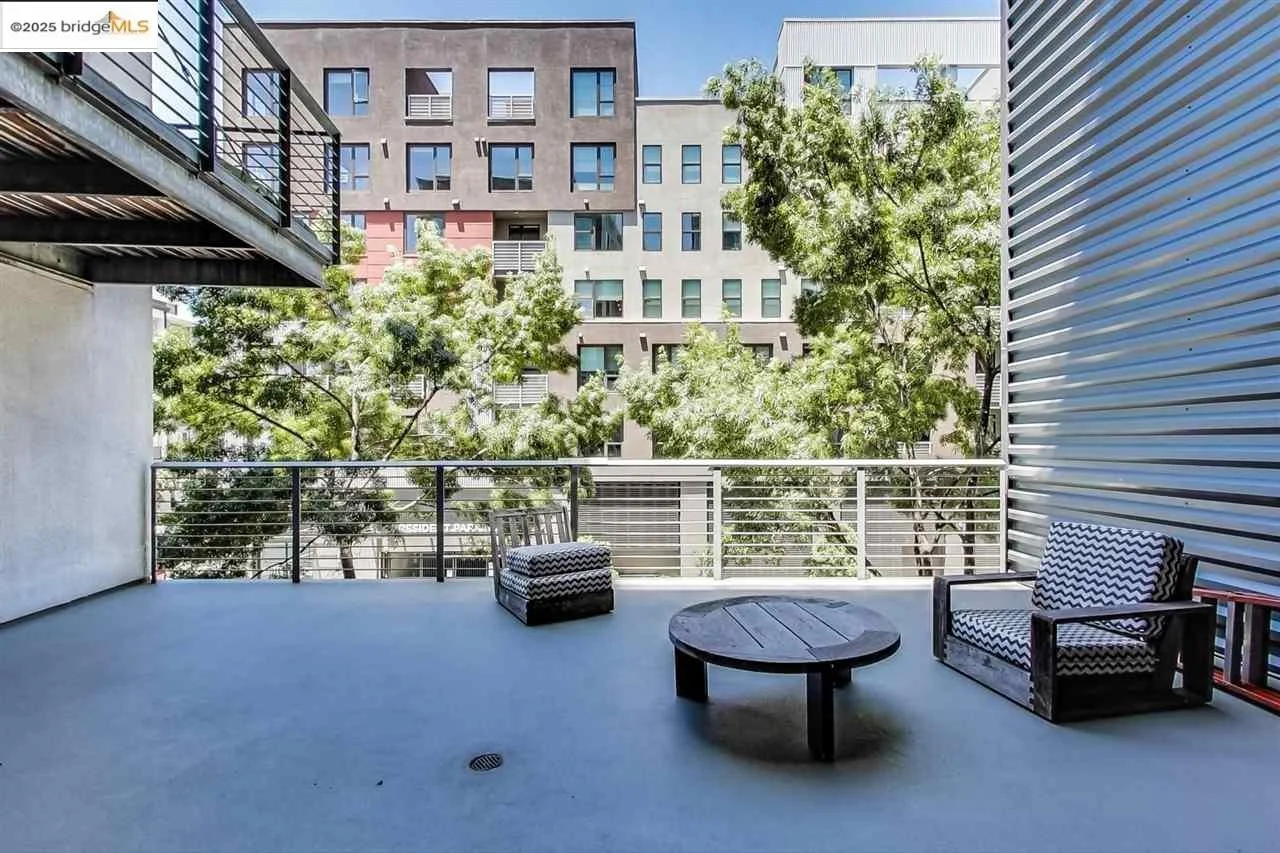 Podium deck on an elevated slab after repairs with a breathable coating, smooth surface with outdoor seating.