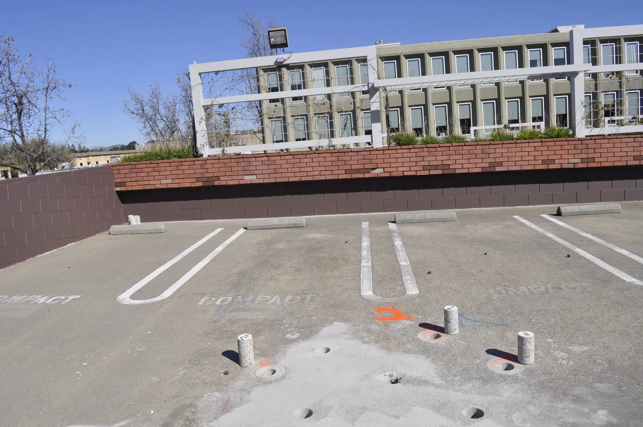 Parking slab with core drill marks and layout lines