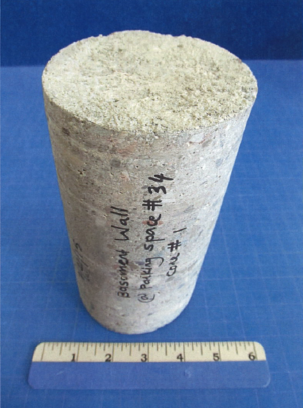 Core specimen labeled for lab analysis with a ruler for size reference.
