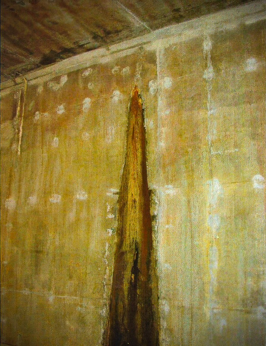 Close-up of a reinforced concrete tunnel wall showing vertical cracking, brown residue buildup, and moisture-related staining and efflorescence.