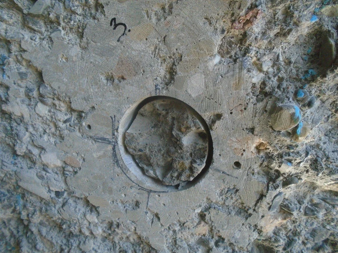 Post-test bond failure location showing cratered concrete area marked with test number.Post-test bond failure location showing cratered concrete area marked with test number.
