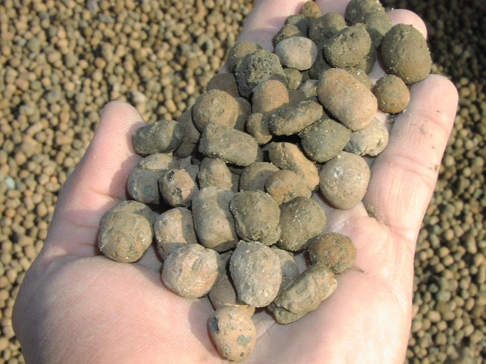 Lightweight expanded clay aggregate (LECA) used to reduce concrete density while maintaining structural strength.