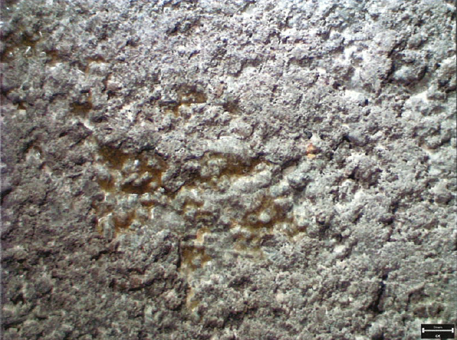 Petrographic microphoto showing surface sealer at the concrete surface and aggregate–paste interface.