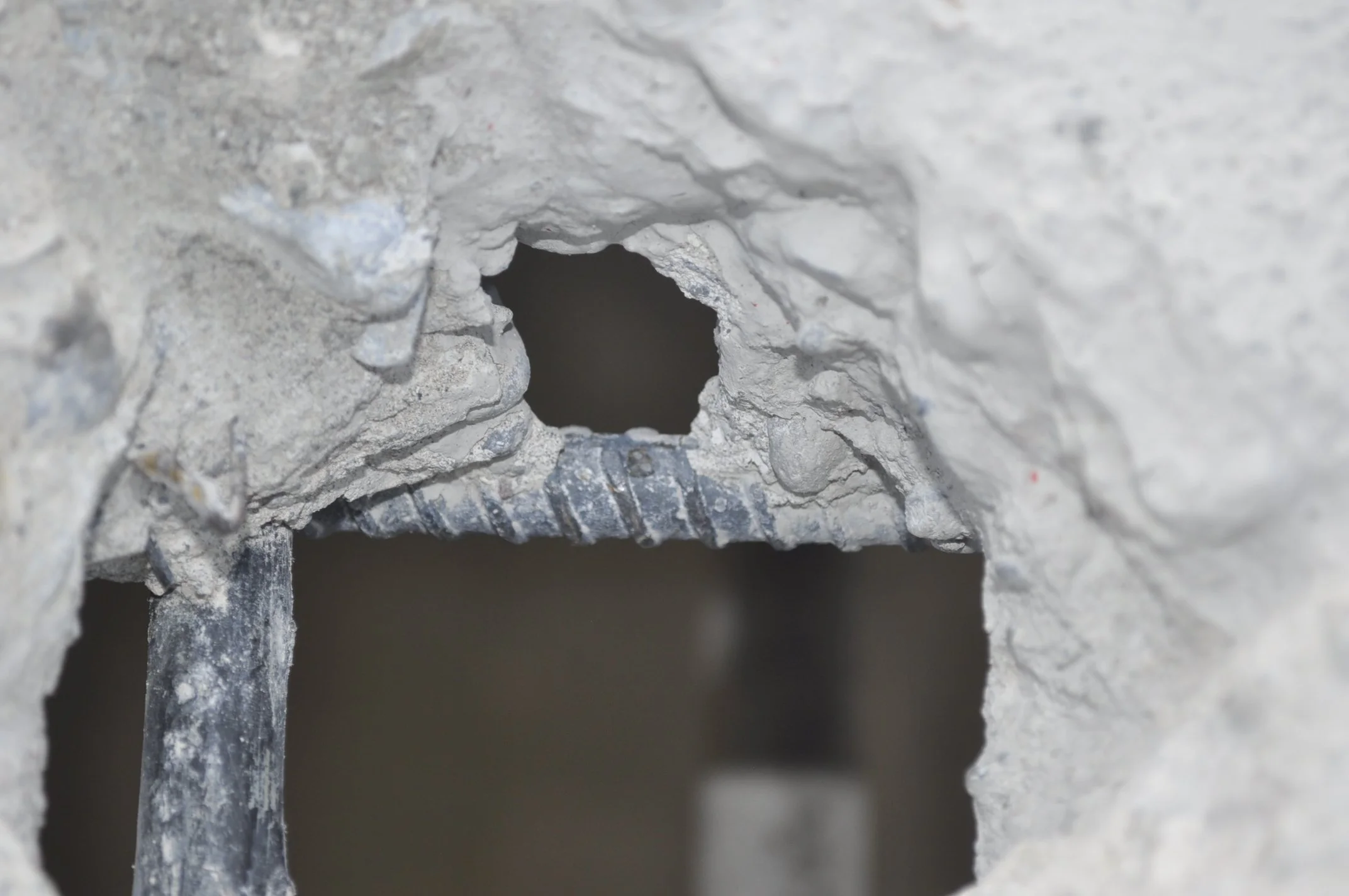 Concrete damage exposing reinforcement bar