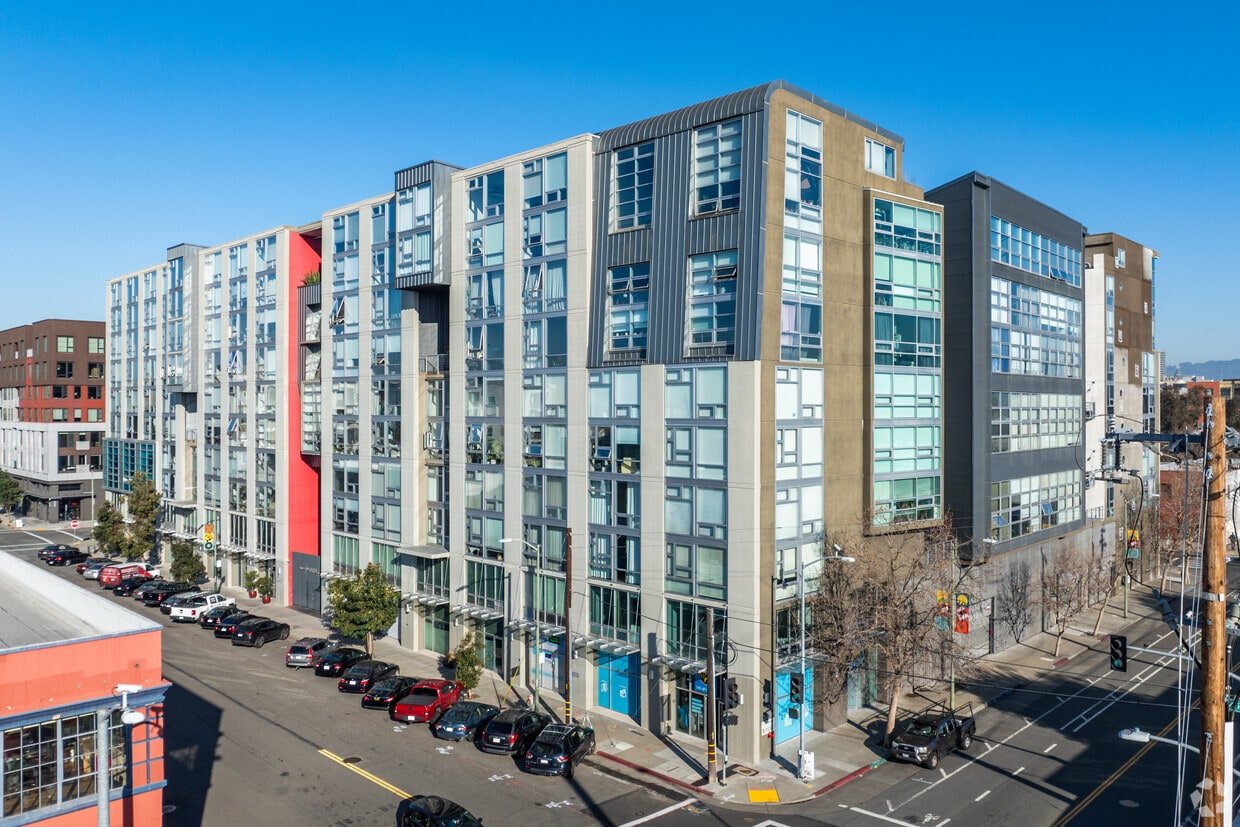 Exterior of a modern mid-rise building at a street corner; hero image for an elevated slab coating case study about trapped moisture.
